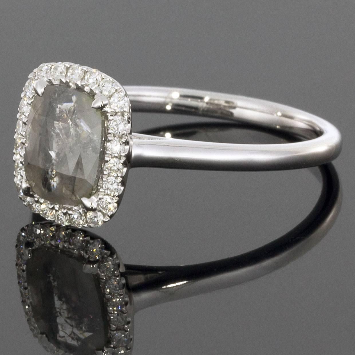 This beautiful grey diamond engagement ring is a unique twist on a classic halo style ring. The rough cut cushion shaped diamond is .42 carats and is surrounded by white round diamonds that weigh .14CTW.

DETAILS:
.56CTW diamonds
.42CT center