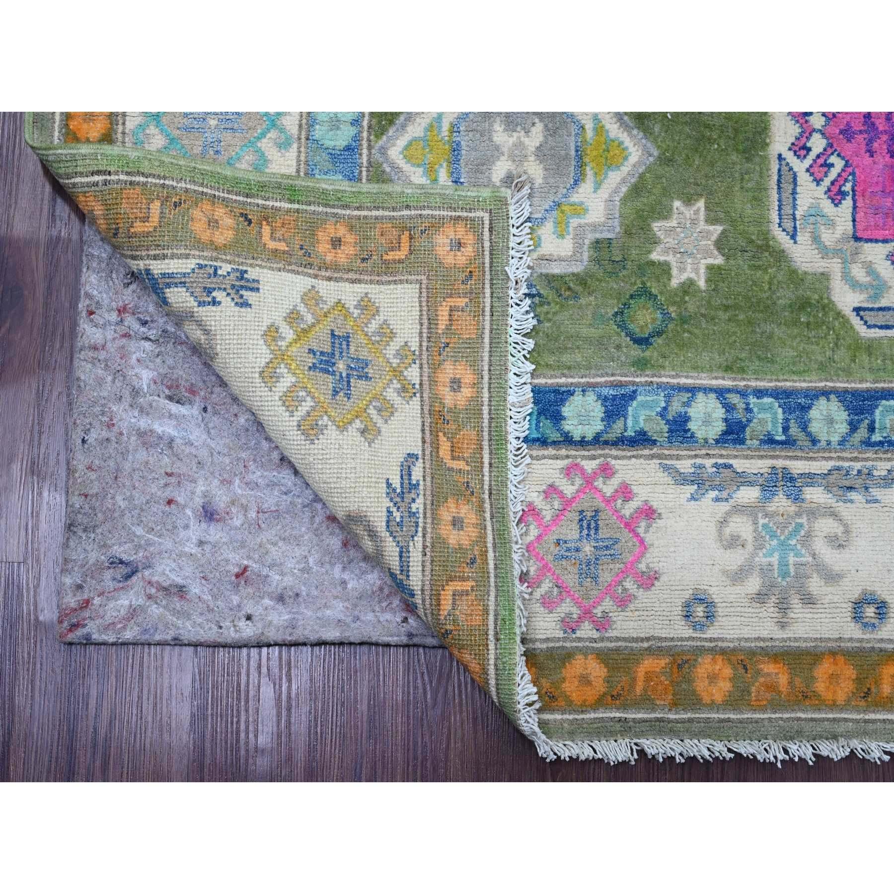 Moss Green, Colorful Fusion Kazak, Caucasian Design, Hand Knotted, 100% Wool, Oriental Rug
Primary materials: Wool
Latex: No Pile 
height: 0.25 Inches
Style: Transitiona
lPrimary color: Green
Secondary colors: Blue, Pink, Yellow, Gray
Pattern: