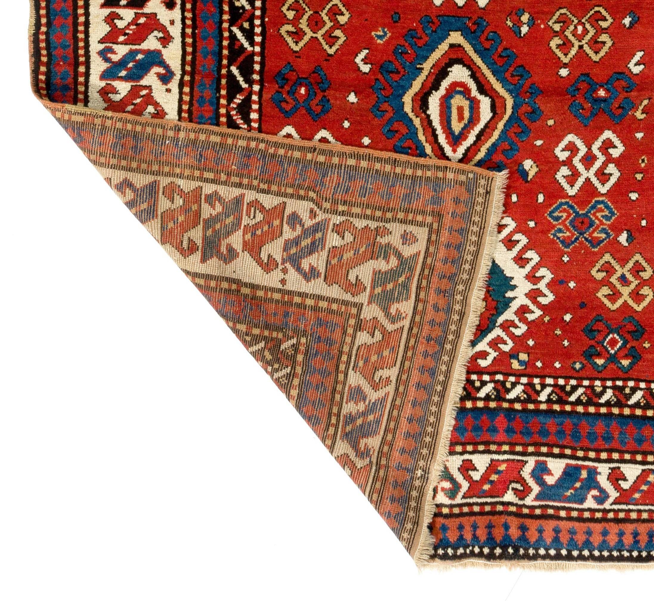 A South Caucasian Kazak rug with an archaic design and wonderfully saturated natural dyes. Very good condition with medium wool pile on wool foundation. Dates back to 1850s. 
Size: 5.6 x 8 ft.