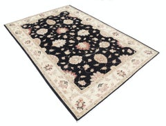 5.6x8 ft Hand Knotted Floral Area Rug with Black Field and Beige Border