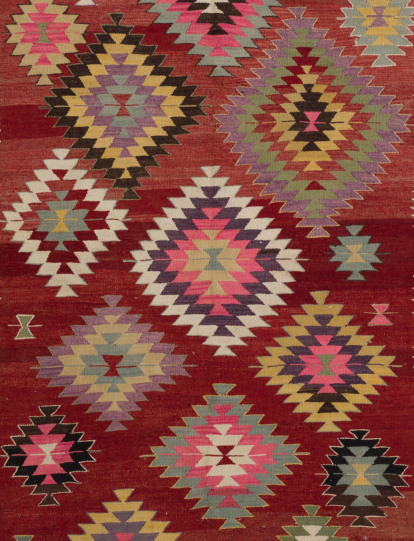 Ein bunter türkischer Kelim im Vintage-Stil. Ein flachgewebter Teppich aus Wolle in ausgezeichnetem Zustand. 

Dieser bezaubernde Kelim zeichnet sich durch gestufte, ineinander verschachtelte Rautenmuster aus, die in verschiedenen Größen und in