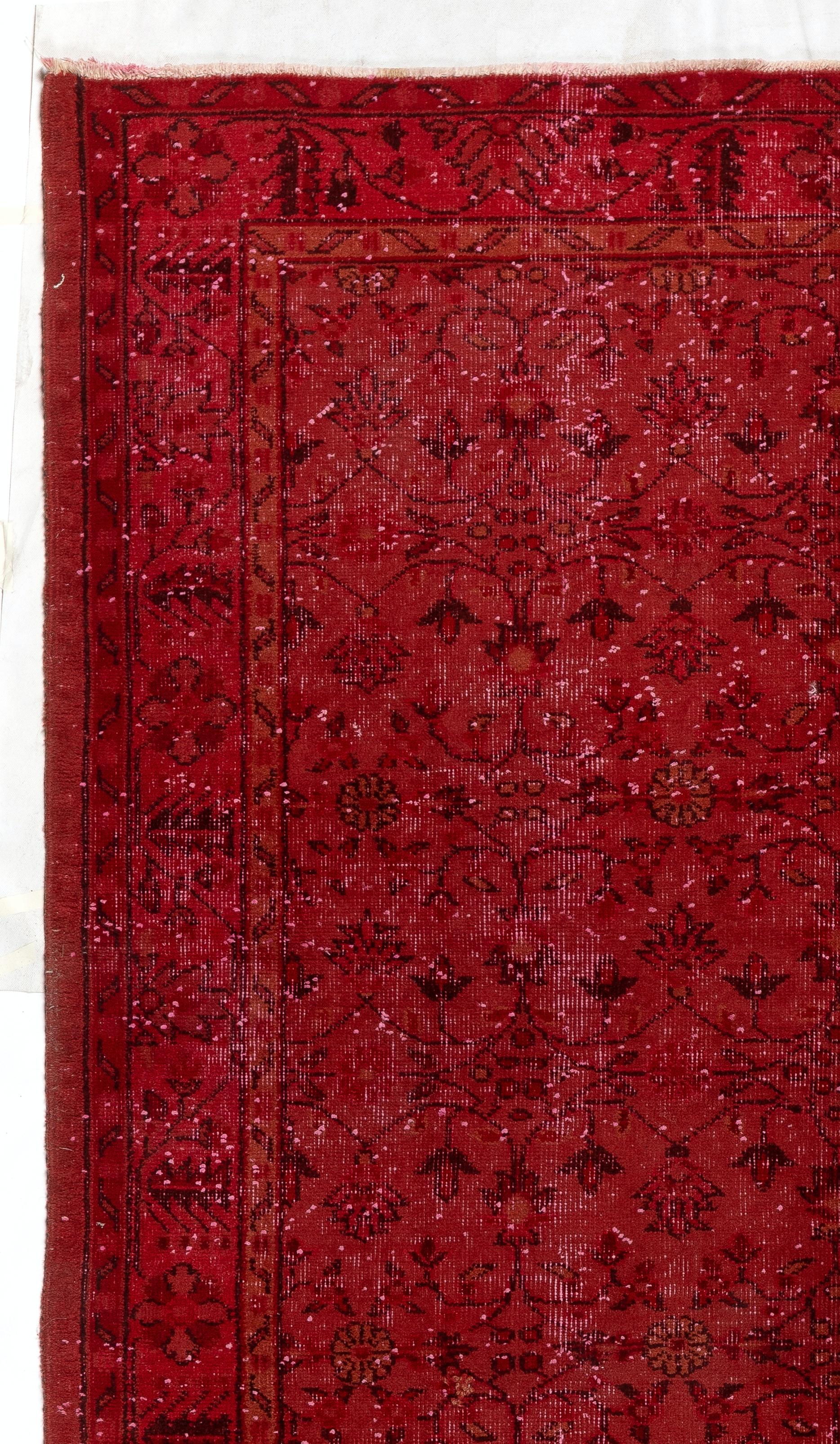 A vintage Anatolian rug re-dyed in red color. Measures: 5.6 x 9.2 ft.
Finely hand knotted, low wool pile on cotton foundation. Deep washed.
Sturdy and can be used on a high traffic area, suitable for both residential and commercial interiors.