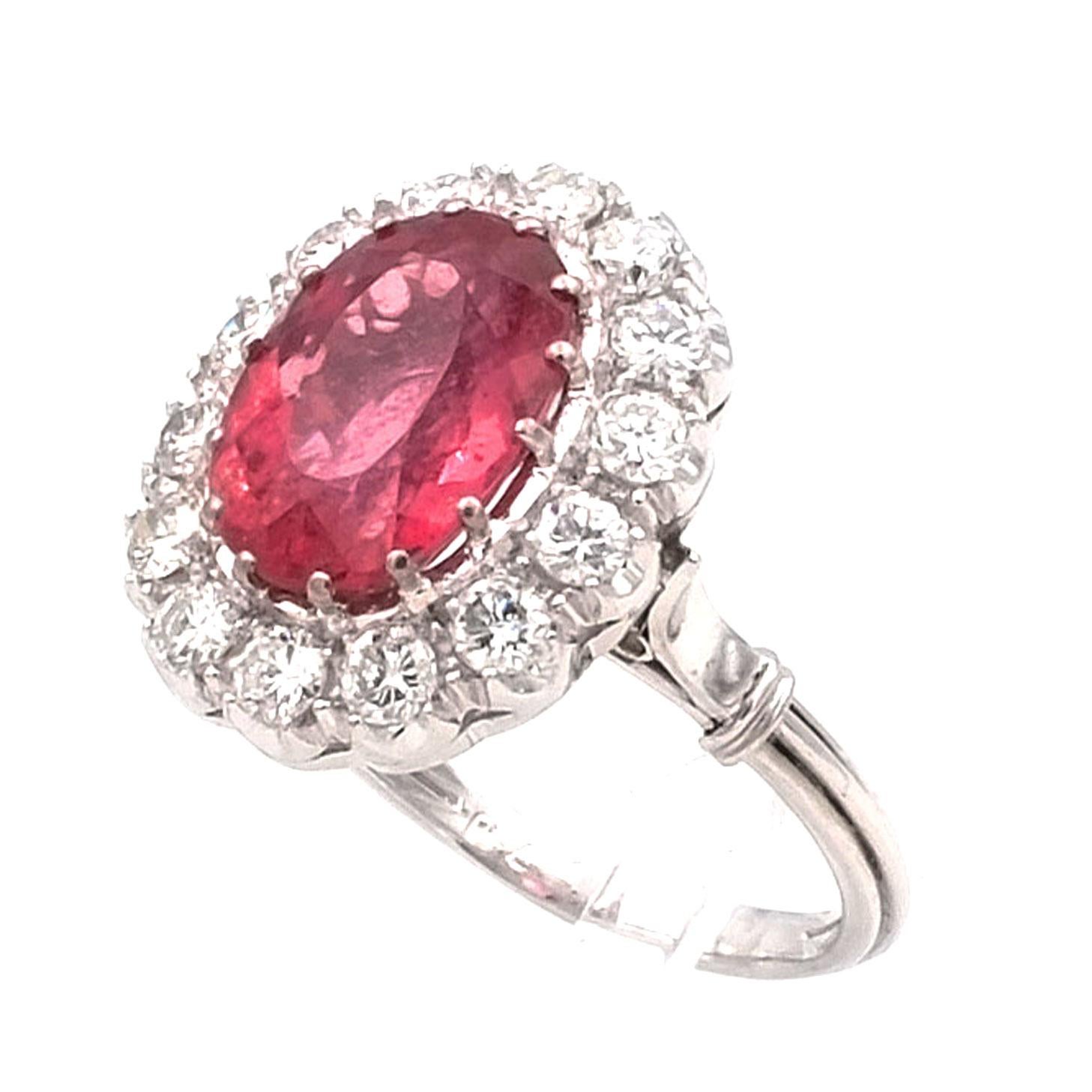 5.7 Carat Rubellite and 1.4 Carat Diamond White Gold Ring

Classically elegant diamond entourage ring, the face set with an oval pink rubellite of 5.7 ct surrounded by a wreath of 14 brilliant diamonds with a total of 1.4 ct, in a lattice-like
