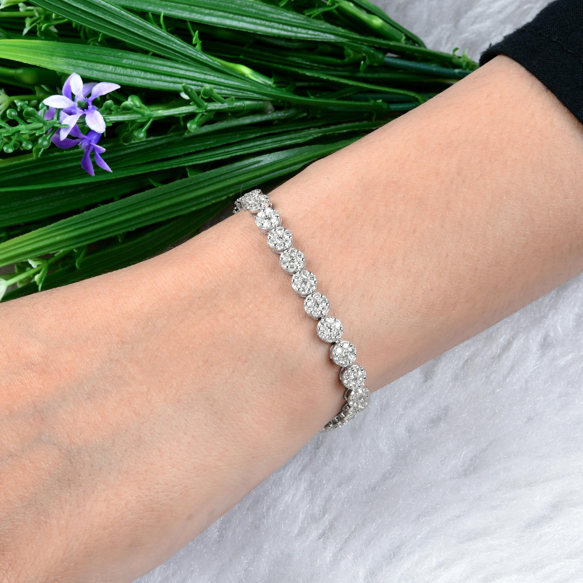 Esta pulsera de tenis de oro blanco de 14 quilates con un racimo de diamantes de talla redonda SI/H de 5,7 quilates presenta unos delicados diamantes de talla redonda engastados en un racimo de forma redonda que hacen de colgantes. Los colgantes