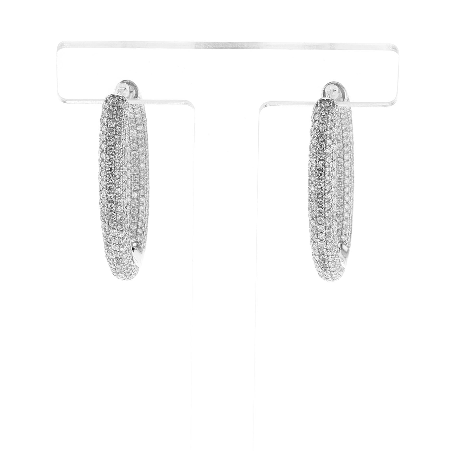 A pair of diamond hoop earrings with 5.78 cts of Diamonds. Total Weight: 17.40 grams. Length: 1.37