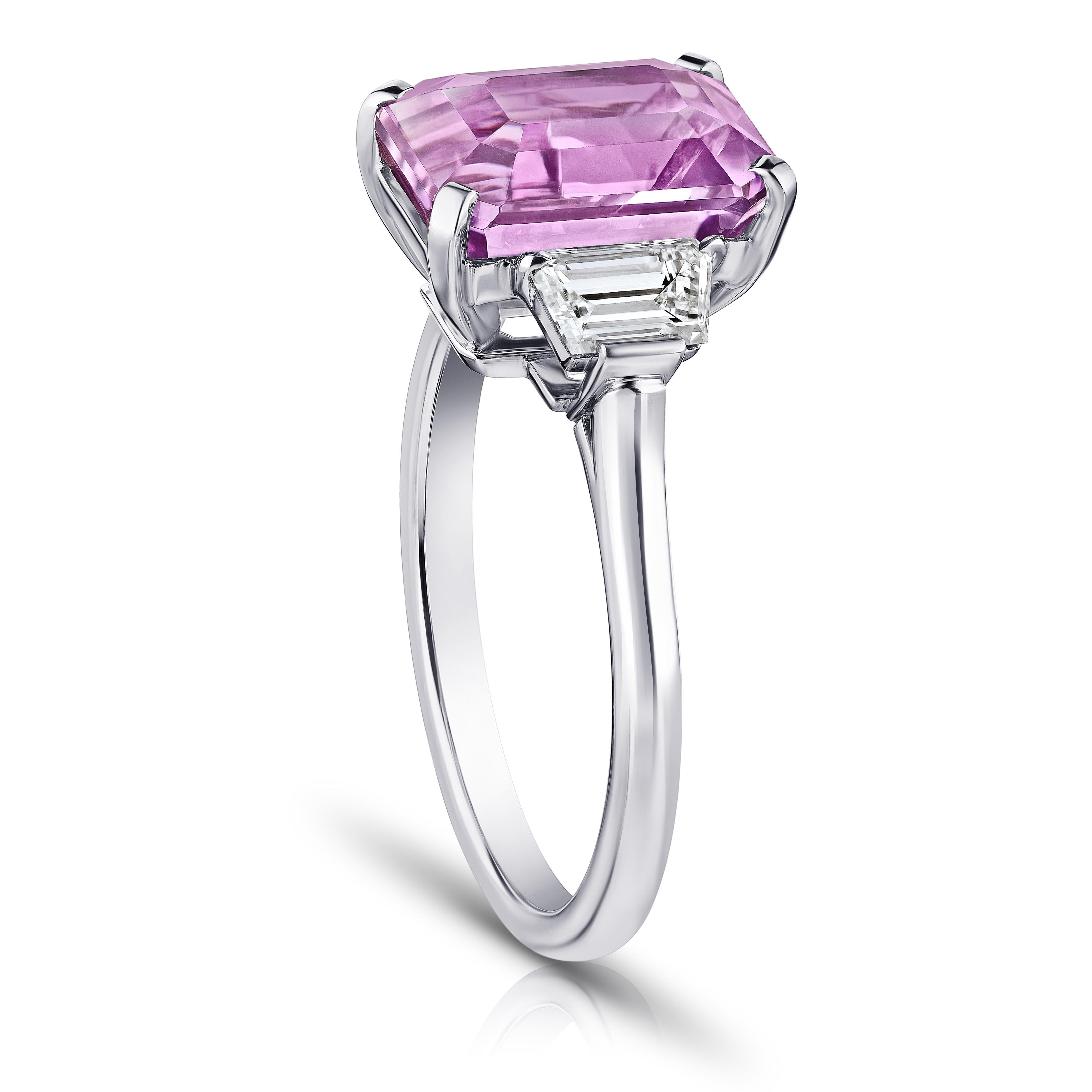 5.70 carat emerald cut pink sapphire with trapezoid step cut diamonds .71 carats set in a ring. Size 7.
