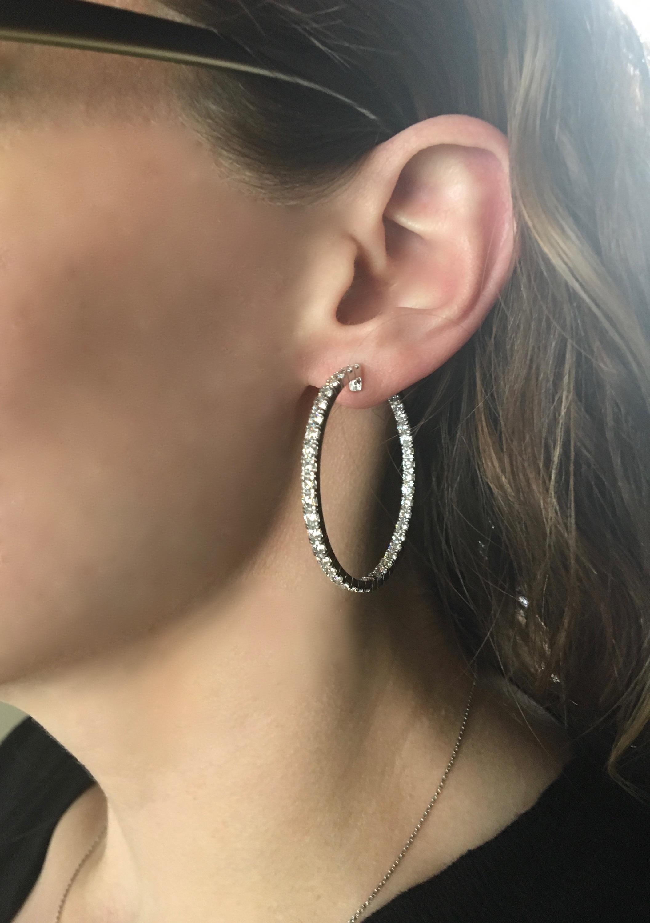 Stunning inside out diamond hoop earrings featuring 5.70ctw of Round Brilliant Cut Diamonds made in 18k white gold.

Diamond Carat Weight: Approximately 5.70CTW 
Diamond Cut: Round Brilliant Diamonds
Color: Average G-I
Clarity: Average VS
Metal: 18K
