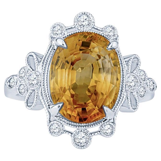 5.70 Carat Orange-Yellow Oval Cut Sapphire w/ 0.20ctw Diamond Accent Ring For Sale