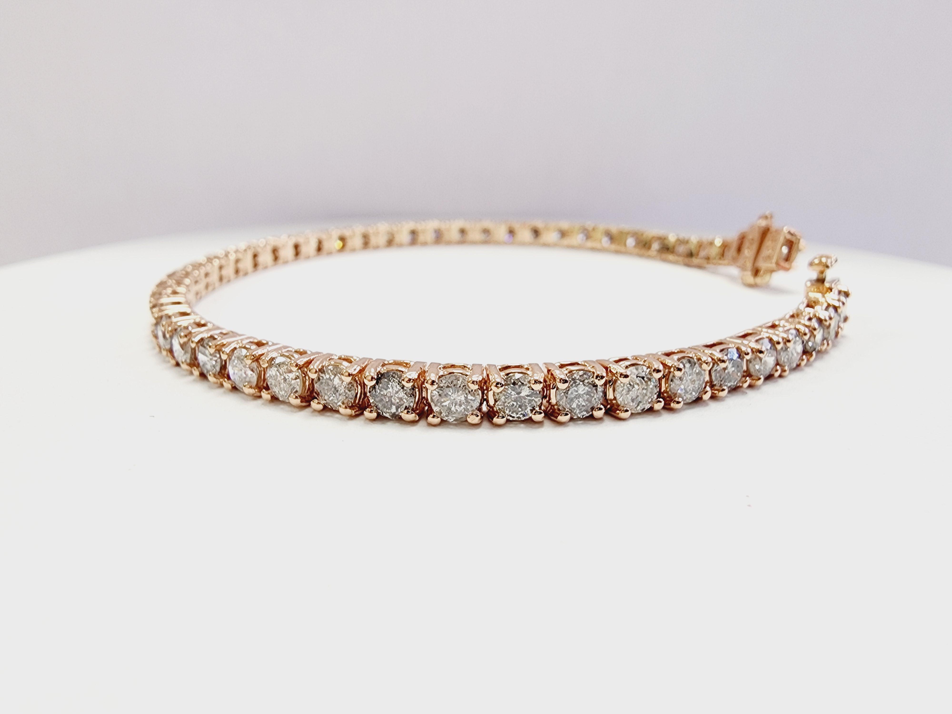 A beautiful natural diamond tennis bracelet featuring 5.70 carats of round brilliant-cut white diamonds. Set in 14k rose gold with a classic four-prong design to enhance light brilliance.

Carat Weight: 5.70 cts

Length: 7 inches

Width: 3.3