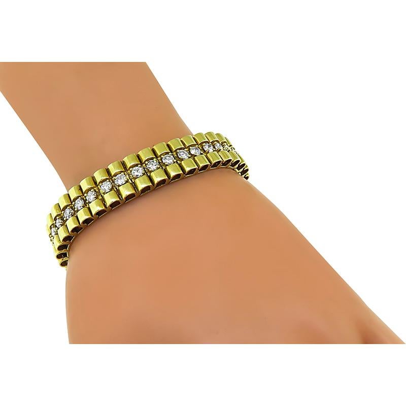 This is an elegant 14k yellow gold bracelet. The bracelet is set with sparkling round cut diamonds that weigh approximately 5.70ct. The color of these diamonds is G with VS2 clarity. The bracelet measures 7 inches in length and 11.5mm in width. The