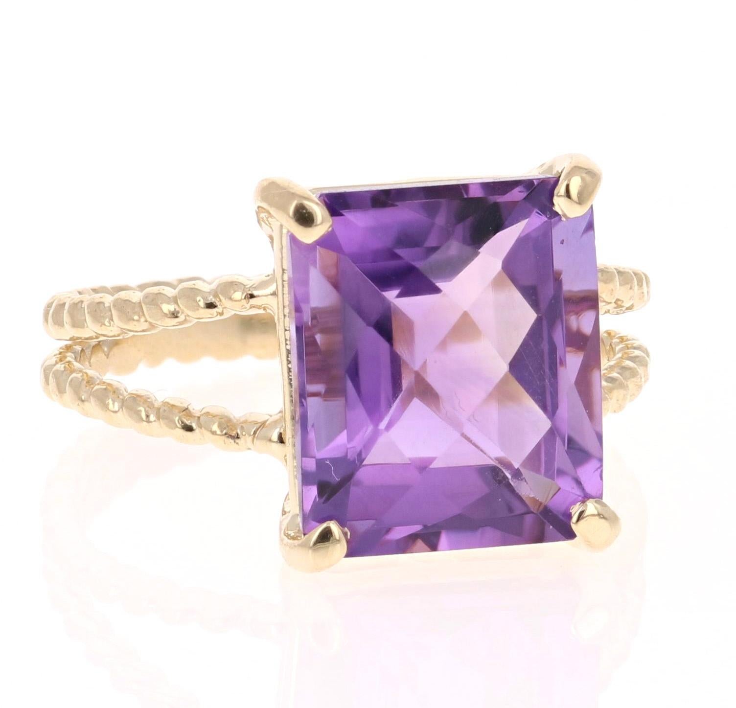This beautiful and simple ring has a bright and vivid Emerald Cut Amethyst in the center that weighs 5.71 carats. 
The setting is beautifully crafted in 14K Yellow Gold and weighs approximately 3.3 grams.
The ring is a size 7 and can be re-sized if