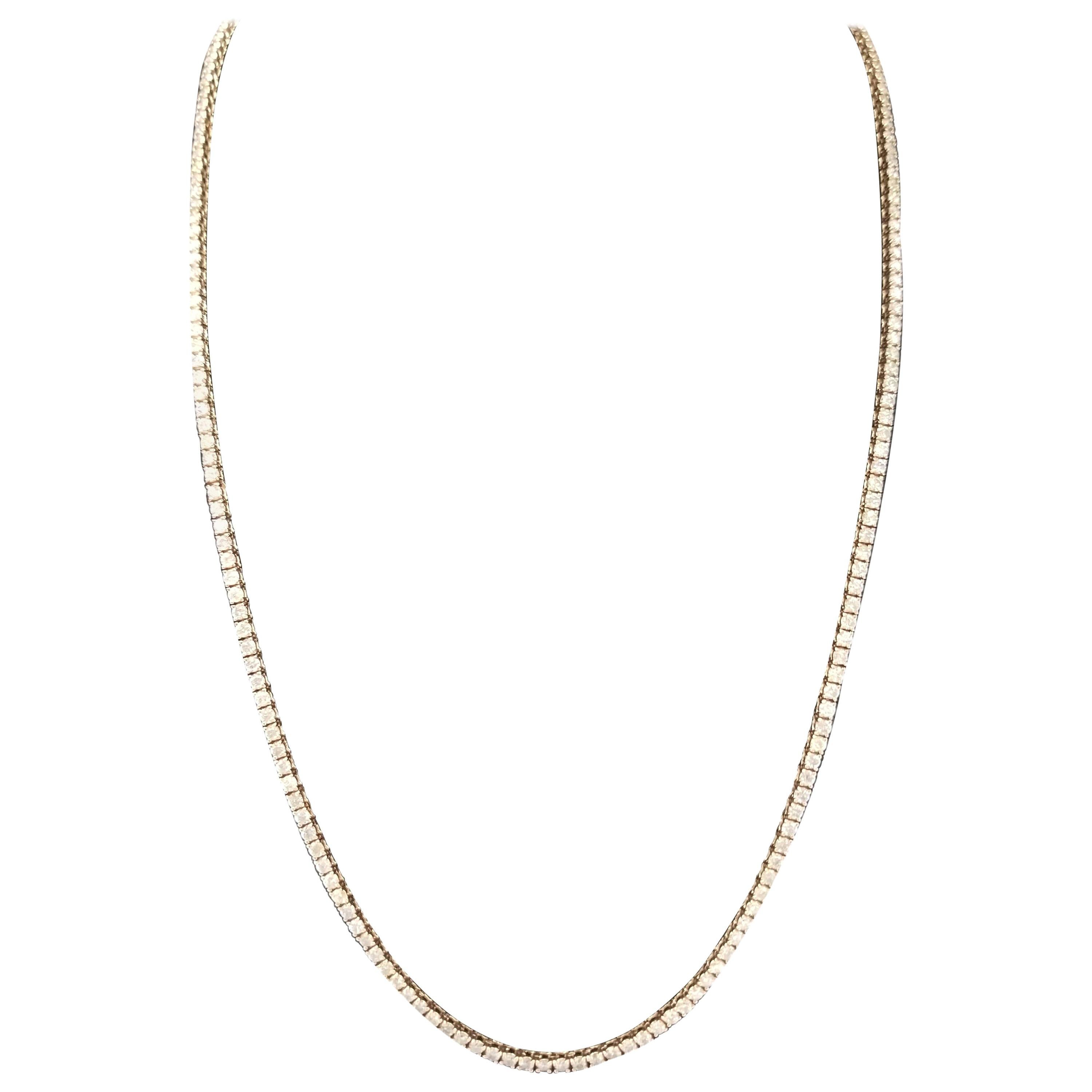 Elegantly simple 14 Karat Yellow Gold Round Brilliant Cut Diamond Tennis Necklace set on 4 prong setting. The total diamond weight is 5.71 carats. The closure is an insert clasp with safety clasp. Length is 18 inches. Average Color H, Clarity VS.