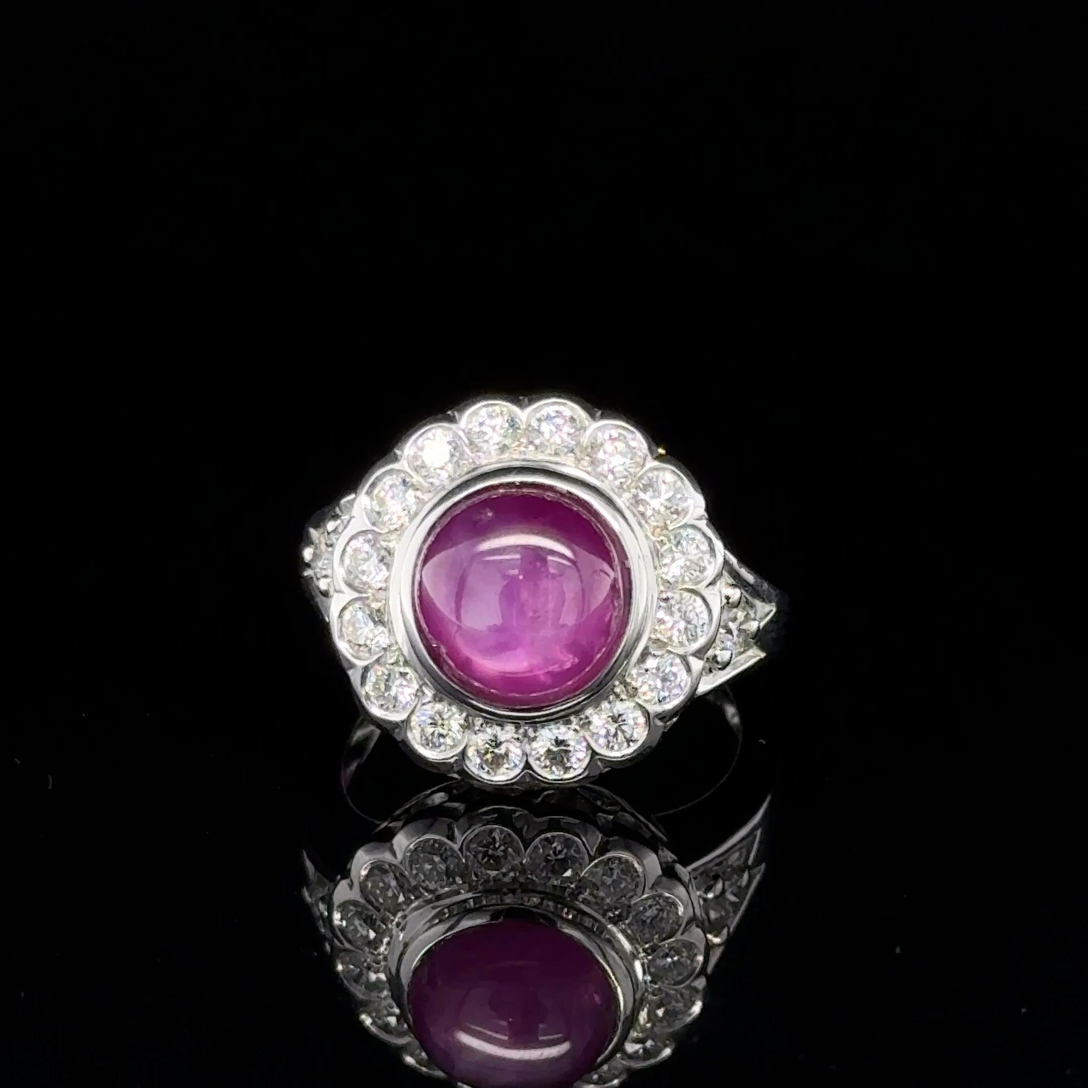 
This exquisite unheated  Burmese star ruby and diamond cluster ring is set in 18k white gold,  and the ruby is round cabochon star ruby with 5.71 carats , surrounded with natural round  brilliant diamonds , the diamonds estimated weigh is 0.88