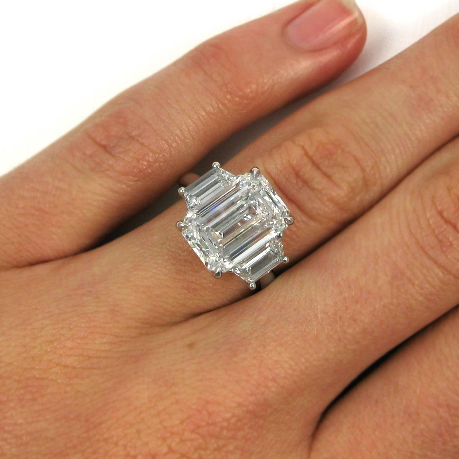 This lovely and significant ring centers on a 5.71 carat emerald-cut diamond with E color and Internally Flawless clarity. The flawless stone is flanked by two trapezoid-cut diamonds totaling 1.18 carats and mounted in platinum. 

Purchase includes