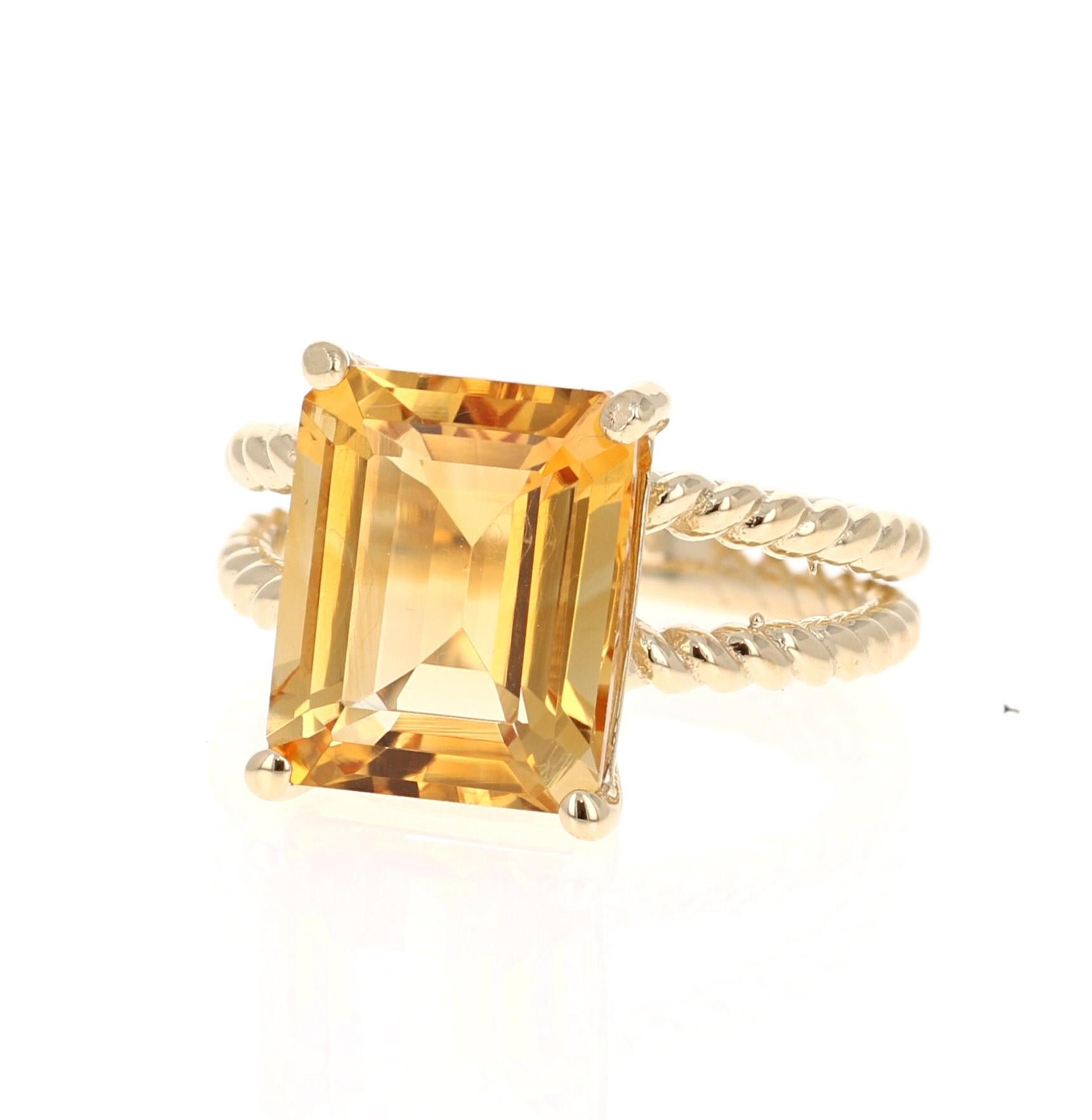This beautiful, designer inspired ring has a bright and vivid Emerald Cut Citrine Quartz in the center that weighs 5.72 carats. 
The setting is beautifully crafted in 14K Yellow Gold and weighs approximately 4.8 grams.
The ring is a size 7 and can