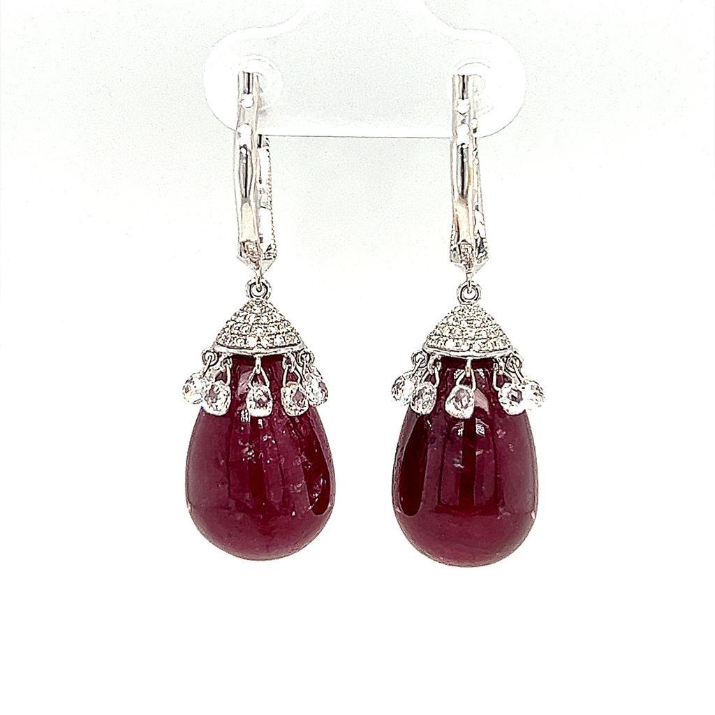This is a stunning teardrop Ruby Dangling Earrings weighing 54.90 carats in total.  This remarkable piece features 142 pieces of Briolette cut and Round Brilliant cut diamonds set on 18 Karat White Gold.

Ruby: 54.90 carats
Diamond: 2.32