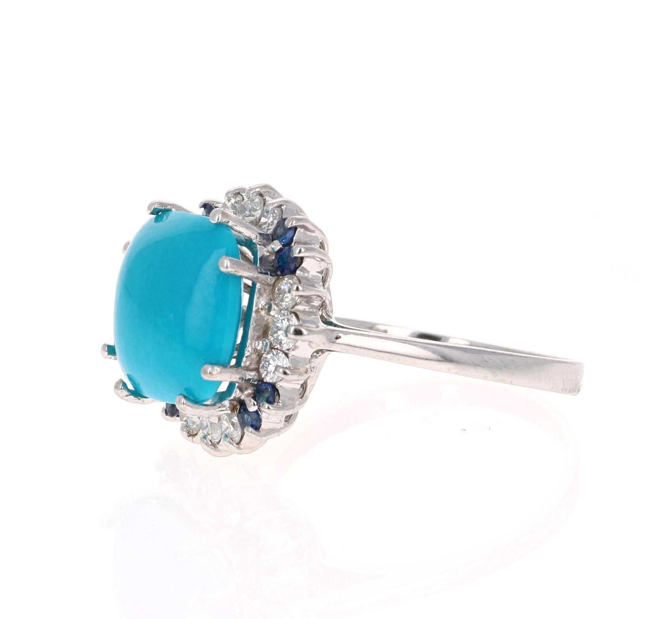 This is a unique beauty! 

The Square/Cushion Cut Turquoise is 5.00 Carats and is surrounded by a cluster of beautifully set diamonds and sapphires. There are 12 Round Cut Diamonds that weigh 0.52 Carats and 8 Round Cut Sapphires that weigh 0.21