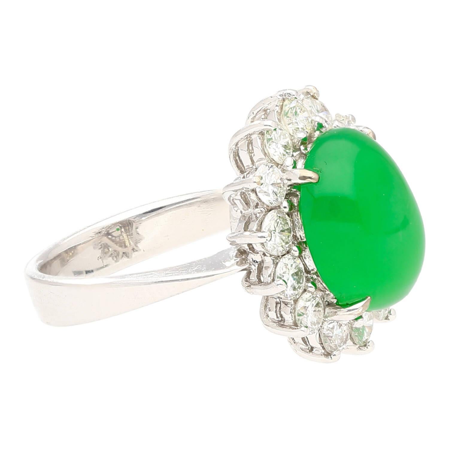 18K white gold Sets a beautiful round cabochon cut 5.74 carat Grade A untreated Jadeite Jade with 14 Round Cut Diamonds of 0.60 CTTW forming a halo around the center stone.

Details: 
 Item Type: Halo Cocktail Ring
 Metal: 18K White Gold
 Weight:
