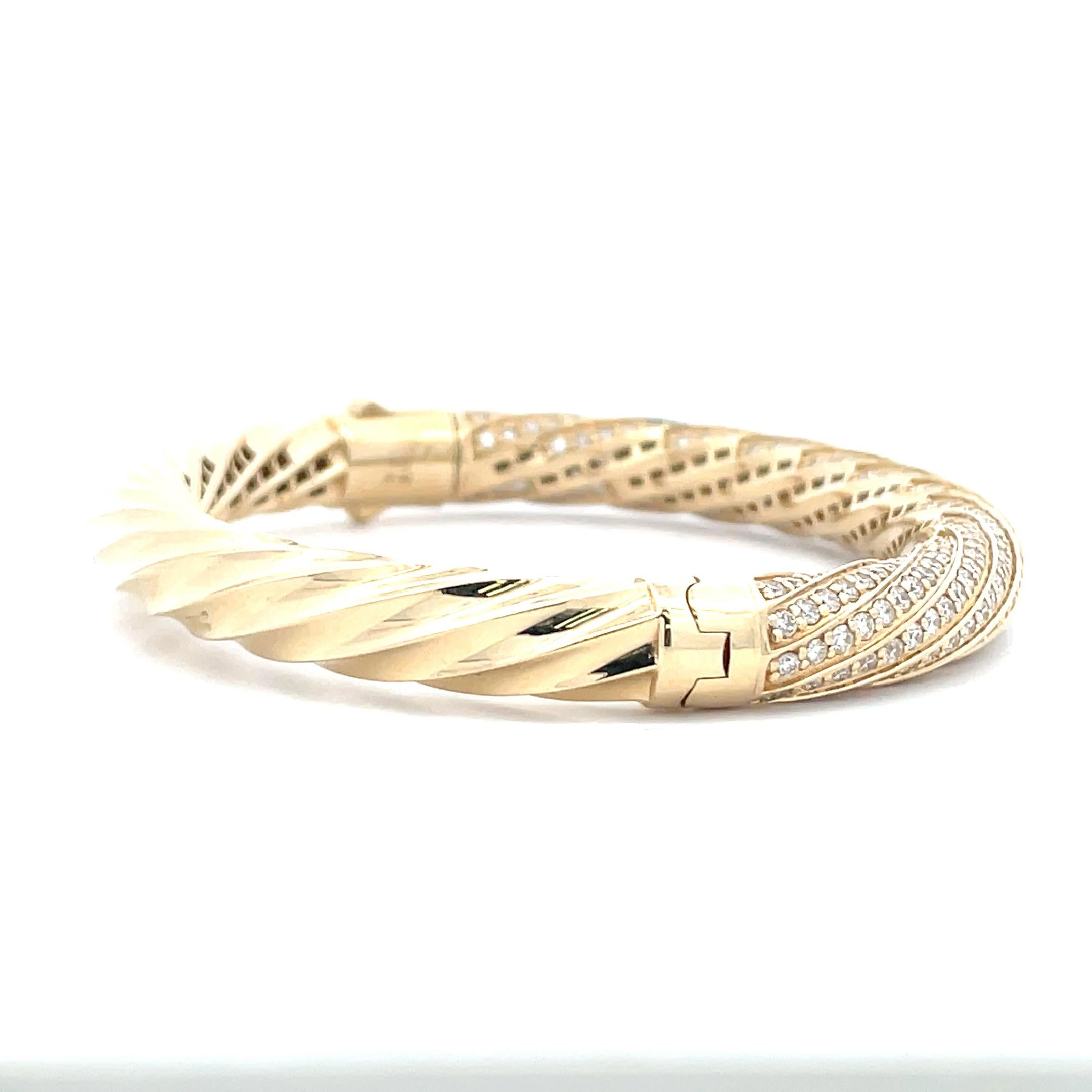 Diamond Cluster Sculpted Cable Bangle is a stylish and elegant way to show off your love of diamonds. Adorned with the vibrant sparkle of 5.74 ct. of diamonds, this unique bangle is the perfect way to add just a touch of flair to any outfit you