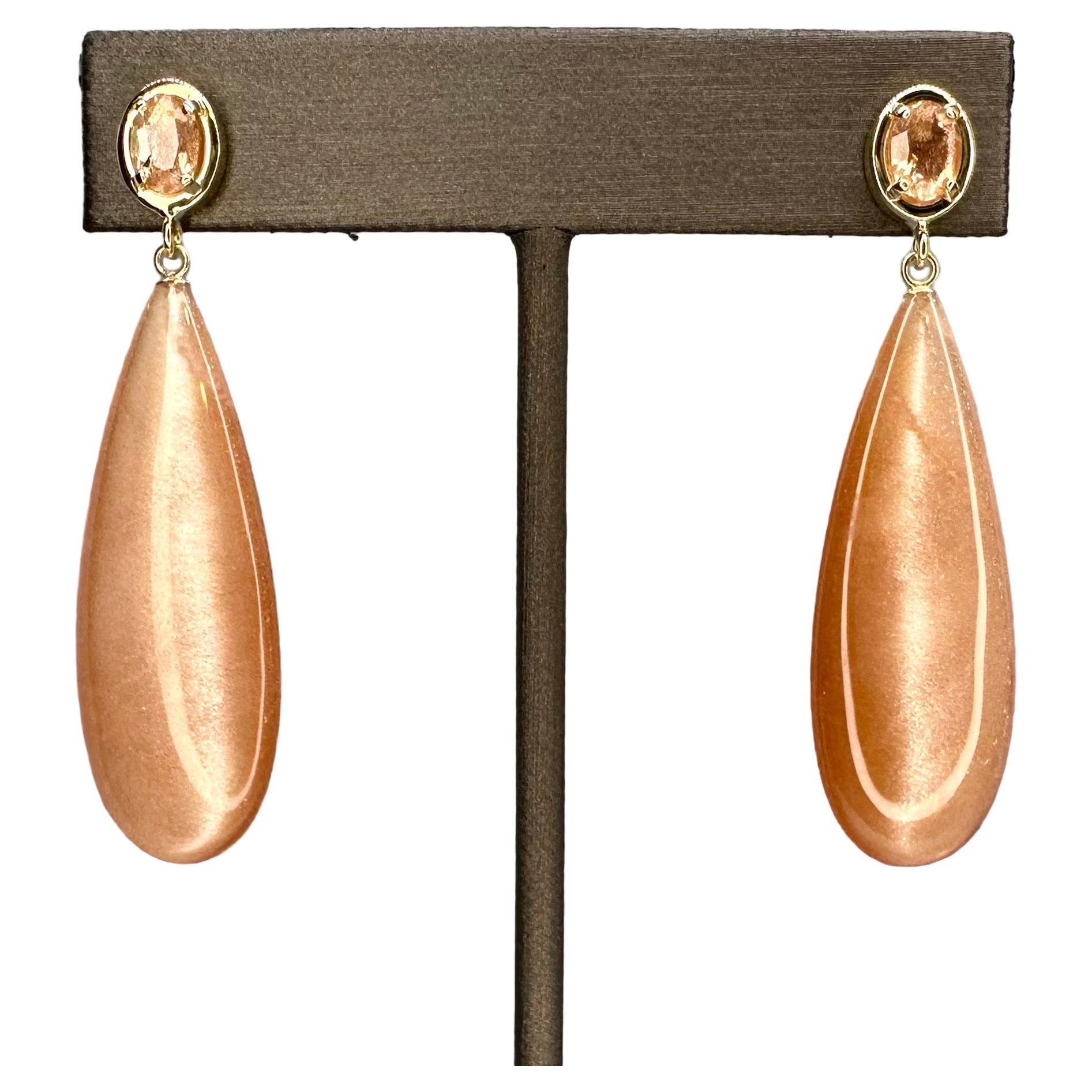 57.43k Tanzanian sunstone drop, oval cut sunstone, and 14k yellow gold earrings For Sale