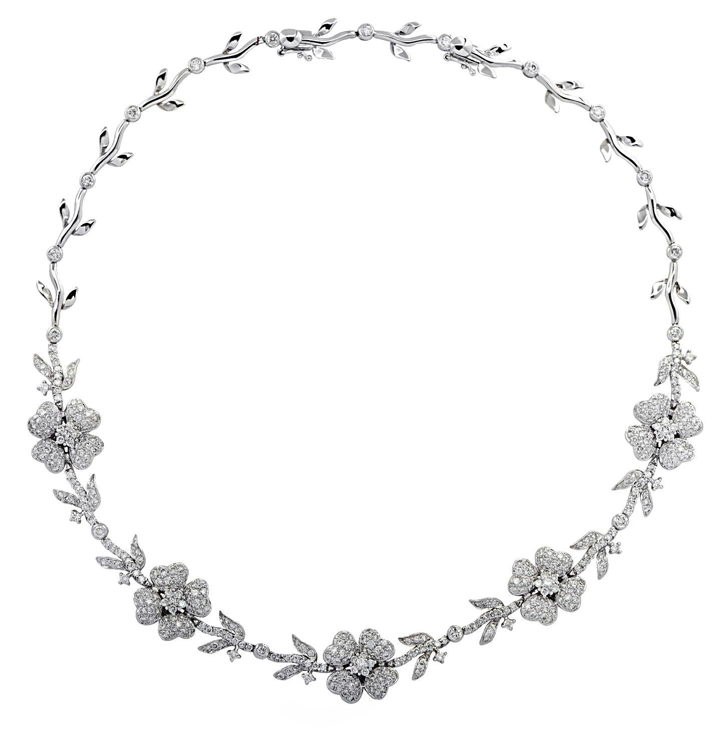 Enchanting necklace crafted in 18 karat white gold, featuring 280 round brilliant cut diamonds weighing approximately 5.75 carats total, G-H color, VS-SI clarity. A delightful diamond encrusted flower garland dances around the neck, capturing the
