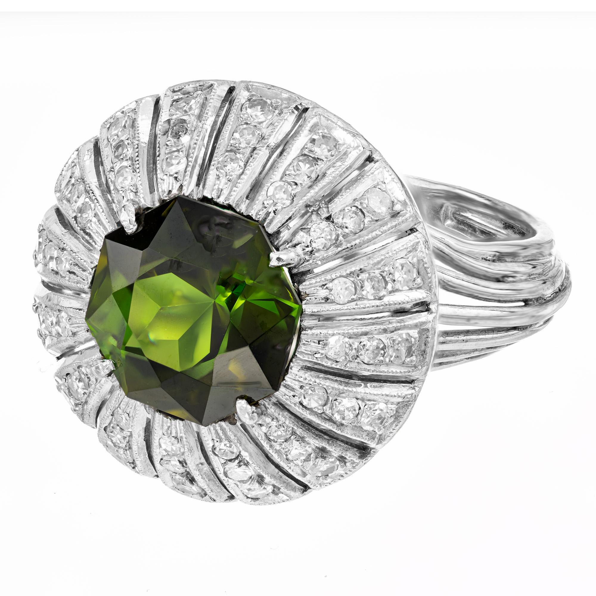1940’s Palladium domed tourmaline and diamond cocktail ring. This captivating show piece begins with a 5.75ct  green 8 sided octagon tourmaline mounted in a cut out raised top. Surrounding the vibrant tourmaline are 48 single cut dazzling diamonds