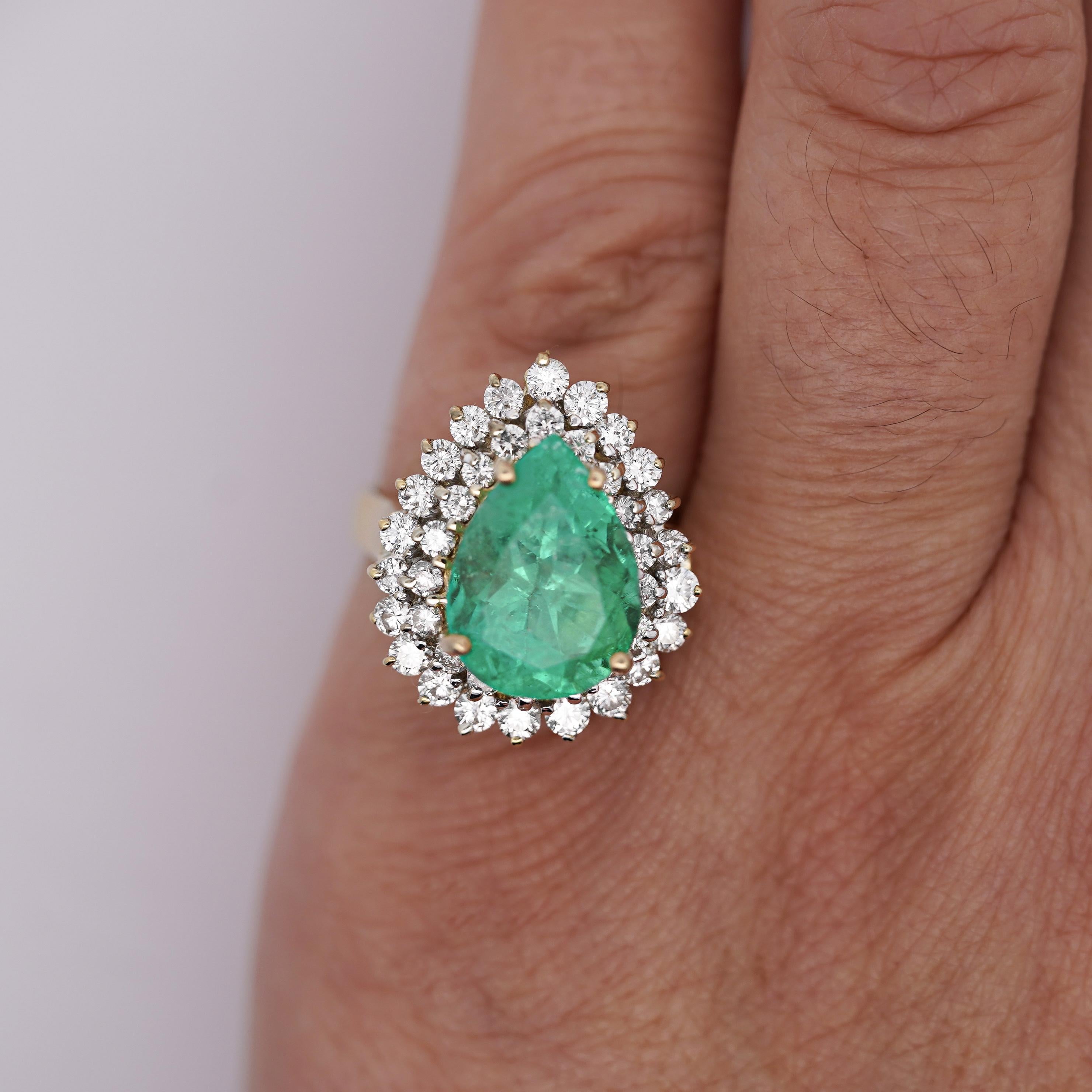 A dazzling 18K yellow gold cocktail ring featuring a stunning 5.75-carat Colombian emerald, framed by 40 round brilliant diamonds for a breathtaking statement of luxury.

Details:
Item Type: Cocktail Ring
Metal: 18K Yellow Gold
Ring Size: 6

Center