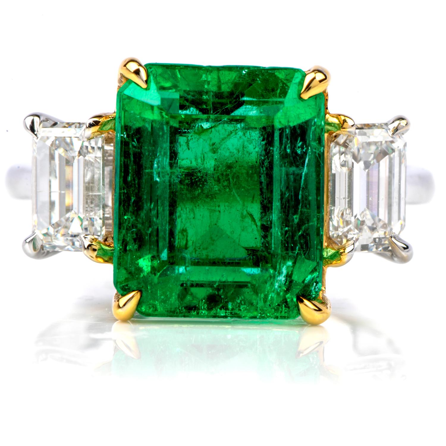 This classic three stone ring is crafted in solid 18k white gold.

It exposes at the center a genuine Colombian Emerald,

weighing 4.65 carats measuring approx.: 10.90mm x 9.0mm x 6.85mm;
and flanked by a pair of genuine baguette diamonds