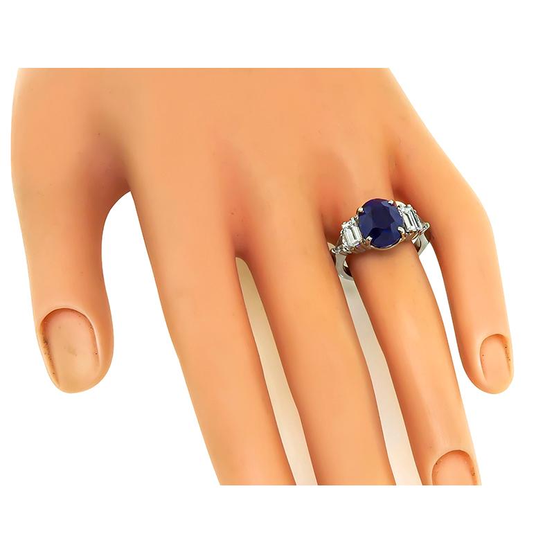 This is a fabulous 18k white gold engagement ring. The ring is centered with a lovely oval cut sapphire that weighs approximately 5.75ct. The sapphire is accentuated by sparkling baguette and trilliant cut diamonds that weigh approximately 1.75ct.