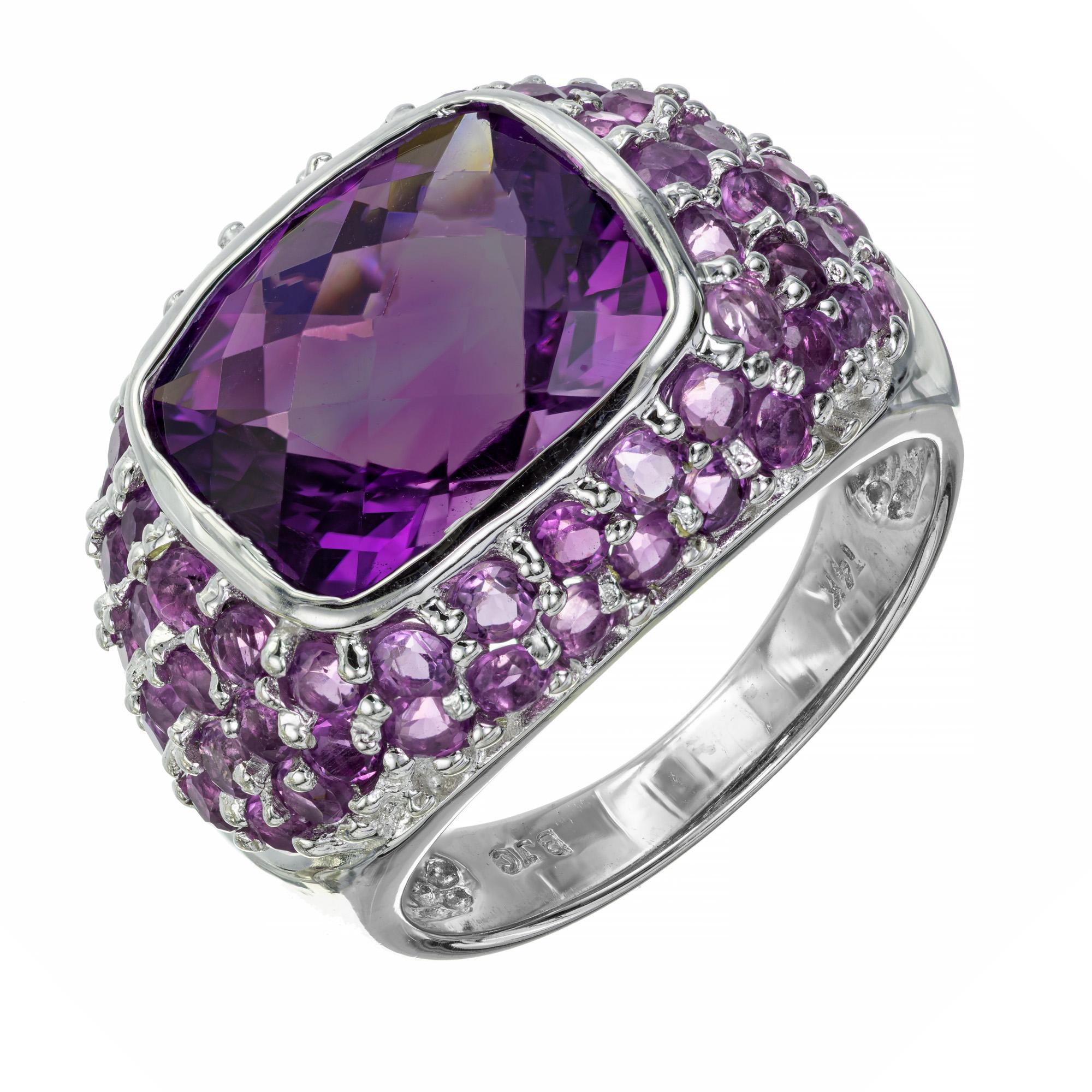 4.00cts center cushion cut bezel set amethyst ring. Set in a 14k white gold setting with 62 round amethyst accent stones in a cluster, cocktail ring setting.  

1 cushion cut Amethyst 10.5 x 9mm, approx. total weight 4.0cts
62 round Amethyst approx.