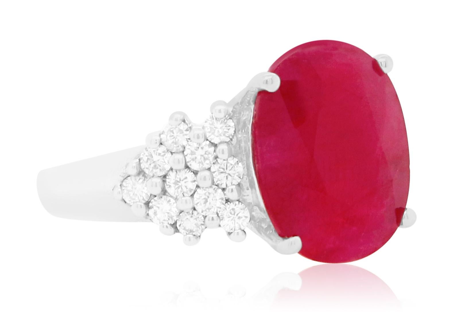 Material: 14k White Gold 
Center Stone Details: 5.76 Carat Oval Ruby measuring 13 x 10.5 mm
Mounting Diamond Details: 22 Brilliant Round White Diamonds at 0.54 Carats - Clarity: SI / Color: H-I
Complimentary sizing on all Alberto rings

Fine