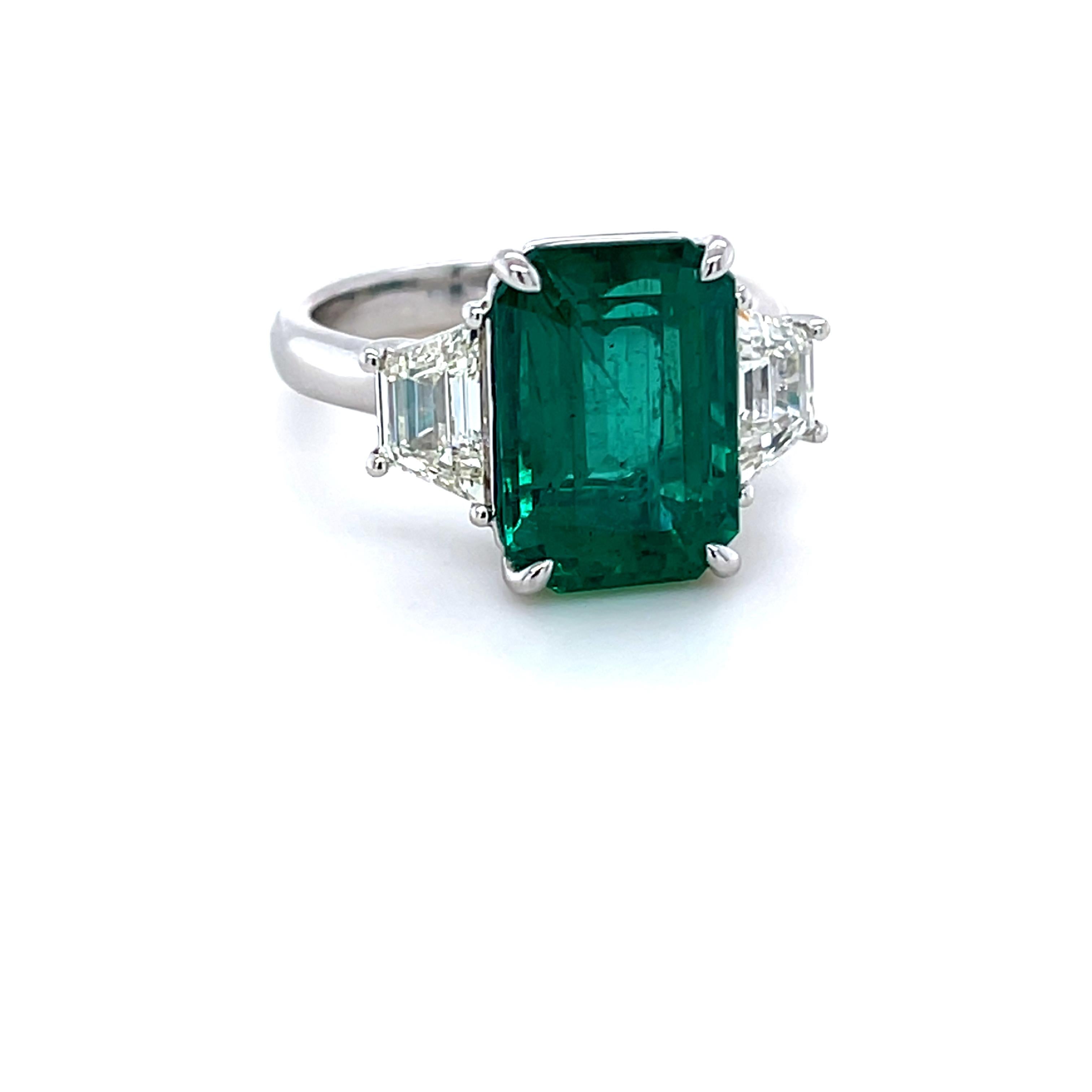 Emerald Cut Emerald weighing 5.77 Carats
Two Trapezoid Diamonds weighing 1.24 carats
Set in Platinum ring