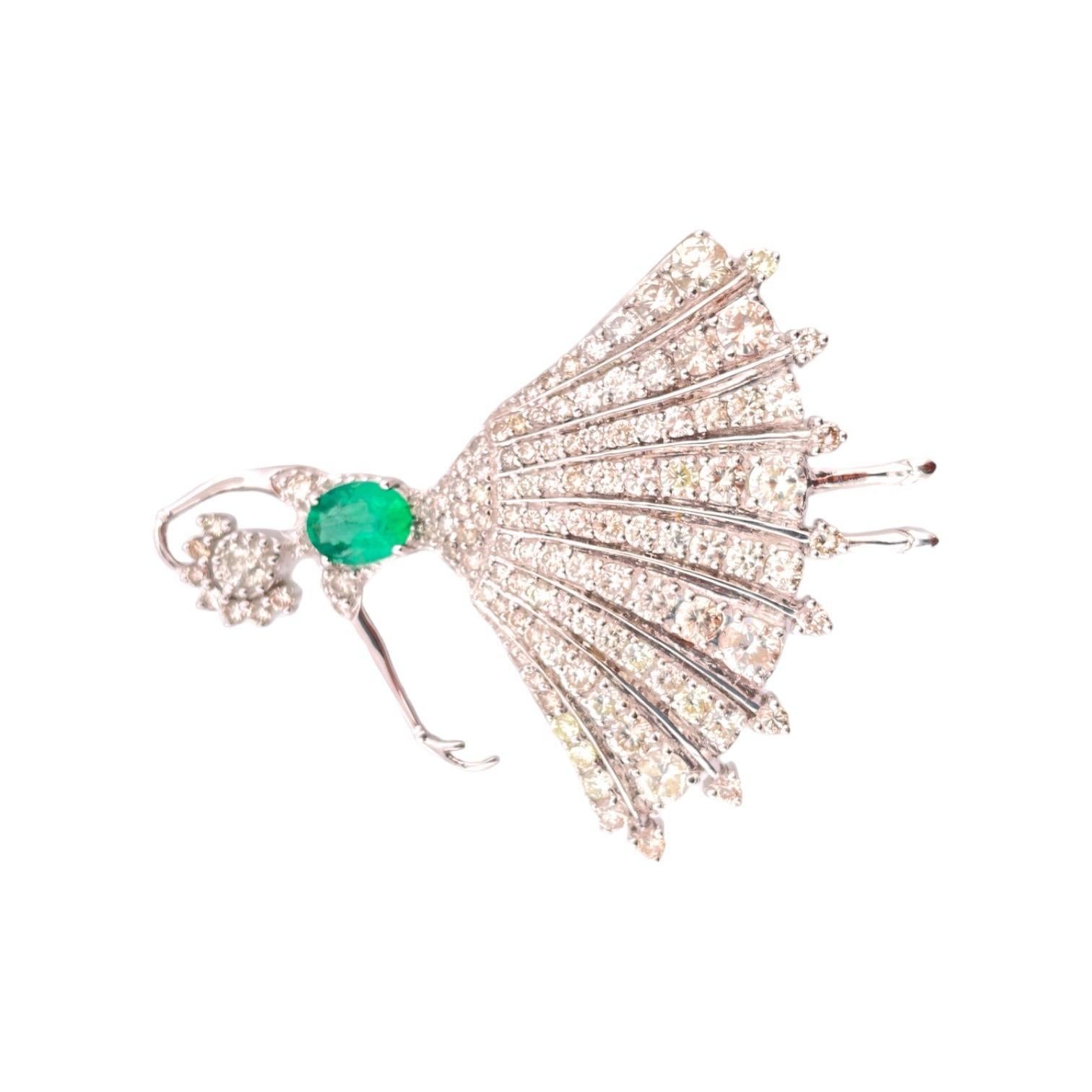 Adorn your attire with the grace and beauty of our Elegant Ballerina Emerald and Diamond Brooch, featuring a total carat weight of 4.76 in 14K white gold. This stunning brooch weighs 18.04 grams and showcases a central 1.03 carat emerald and an