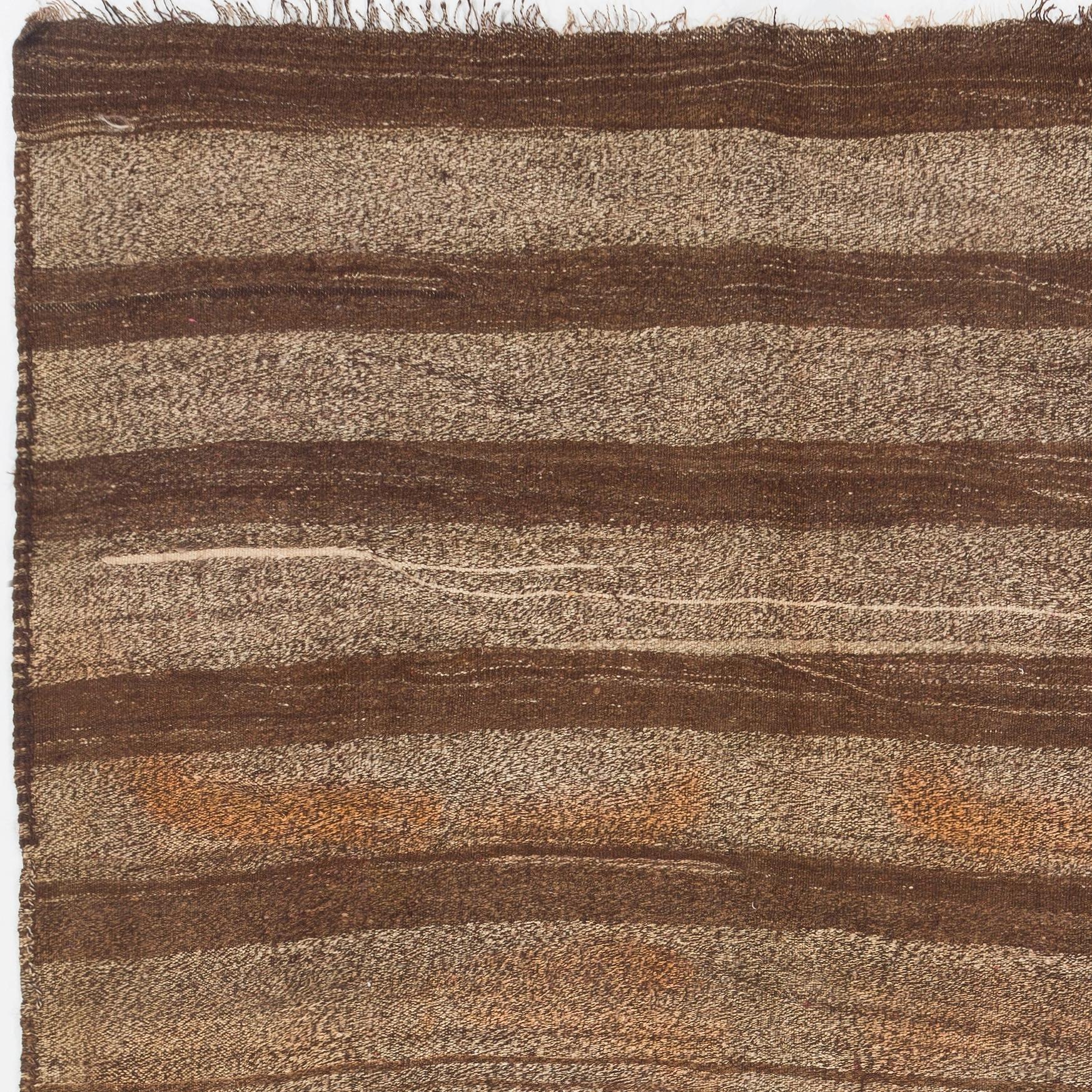A minimalist striped handmade flat-woven vintage Turkish runner rug/kilim with a lovely grainy-looking texture in neutral tones of light brown, dark brown and beige with touches of bright orange and light blue. The rug is made of hand-spun wool,