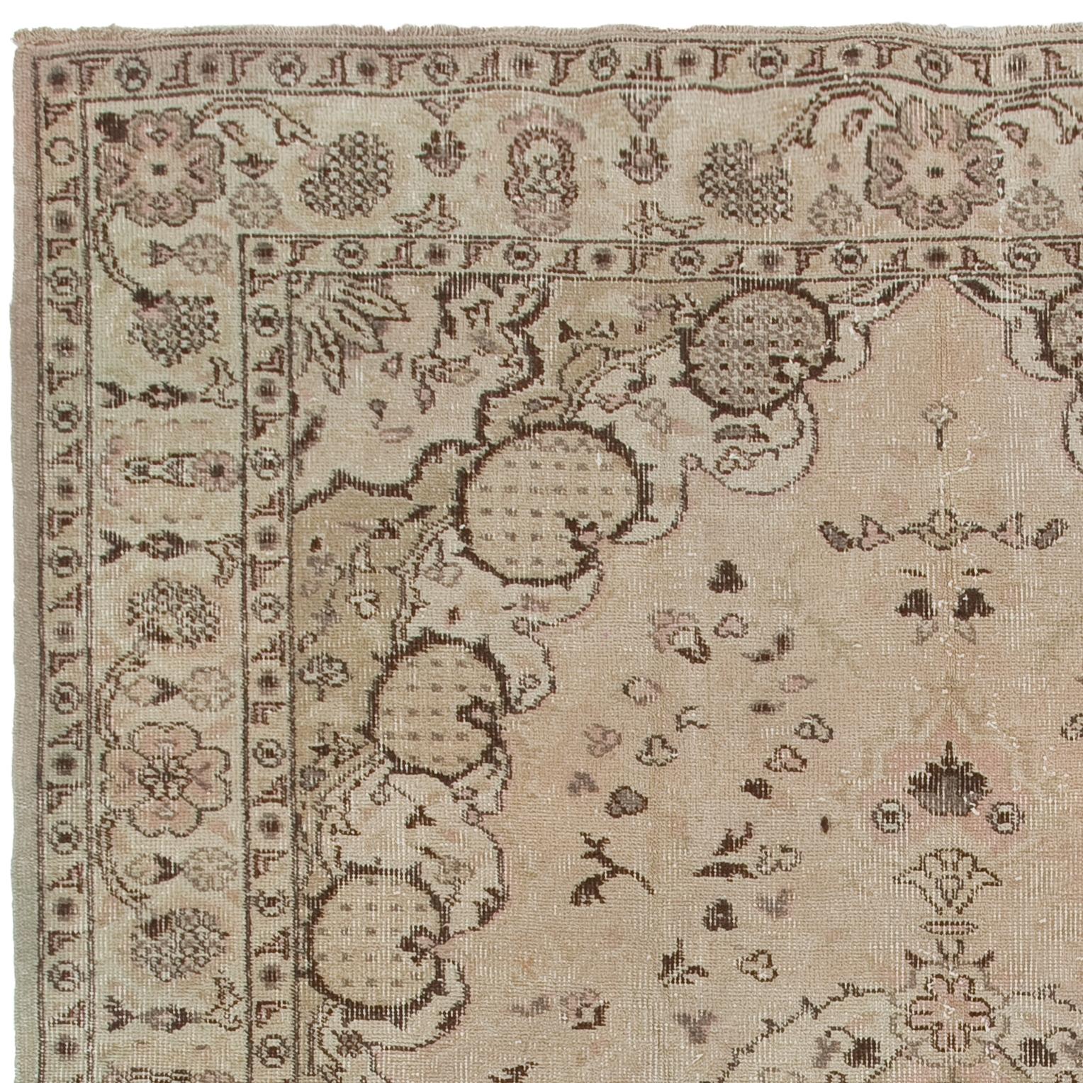 This one-of-a-kind vintage Turkish area rug is finely hand-knotted with low wool pile on cotton foundation. It features an elegant medallion against a field decorated with floating delicate petals framed by corner pieces with pomegranate-like motifs