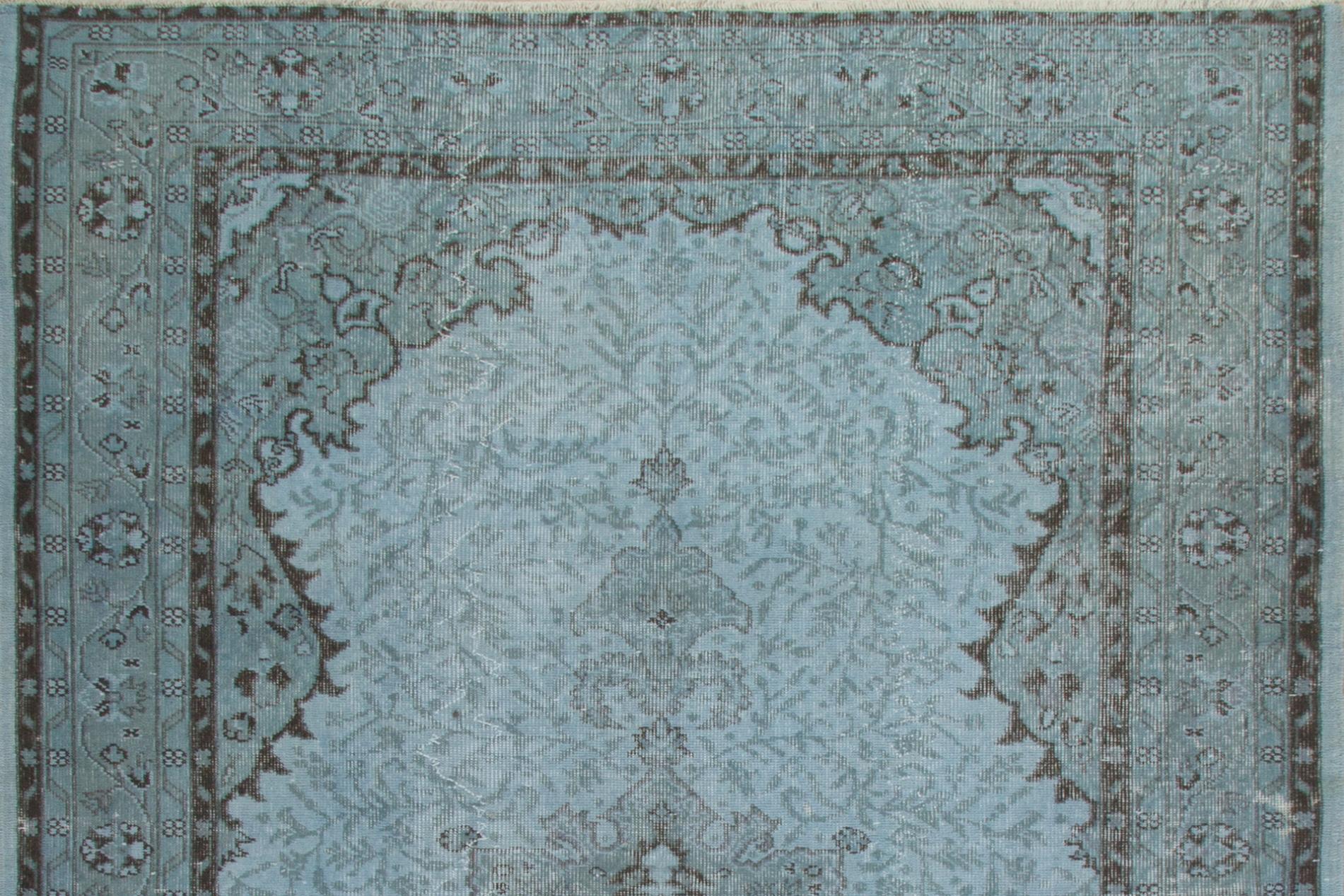 A vintage Turkish area rug over-dyed in light blue color for contemporary interiors.
The rug is finely hand-knotted, has low wool pile on cotton foundation. It is in very good condition, professionally washed, sturdy and suitable for areas with high