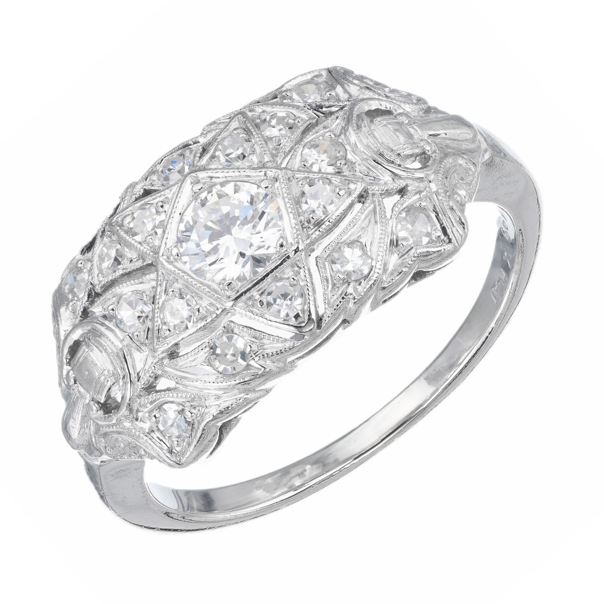 Original 1930's Diamond platinum ring with star design center and hand detailed and pierced top.
 
1 round brilliant cut diamond, approx. total weight .30cts, F, VS2
16 round diamonds, approx. total weight .28cts, F – G, VS1 – SI1
Size 7 and