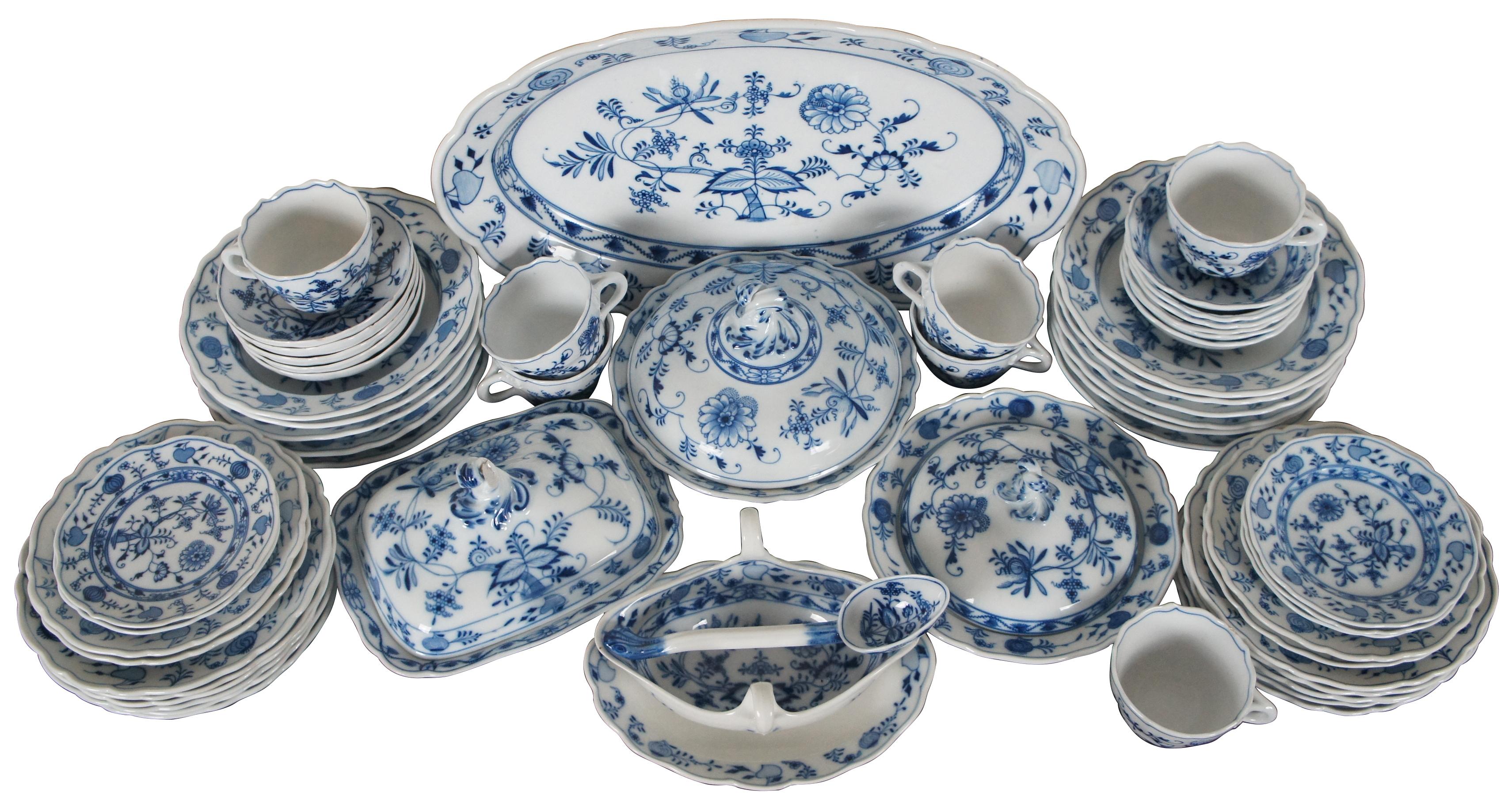 Vintage 58 piece set of flow blue porcelain Meissen dinnerware in the Blue Onion pattern.

Measures: Oval Platter - 19” x 12.5” x 2.5” / Lidded Rectangular Dish - 9.5” x 7.5” x 5.625” / Round Dish Large Lid - 9.25” x 6” / Round Dish Small Lid - 9”