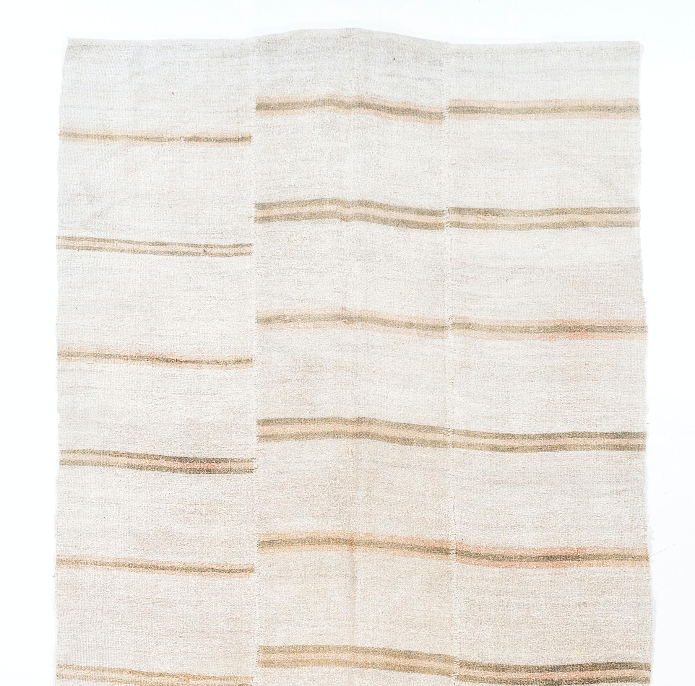 5.8 x 12.4 ft Vintage banded Kilim made of hemp with stripes in faded brown and peach against an ivory background. This flat-weave floor covering was handwoven in Turkey circa 1970. It was first made in three separate bands and then hand-stitched.