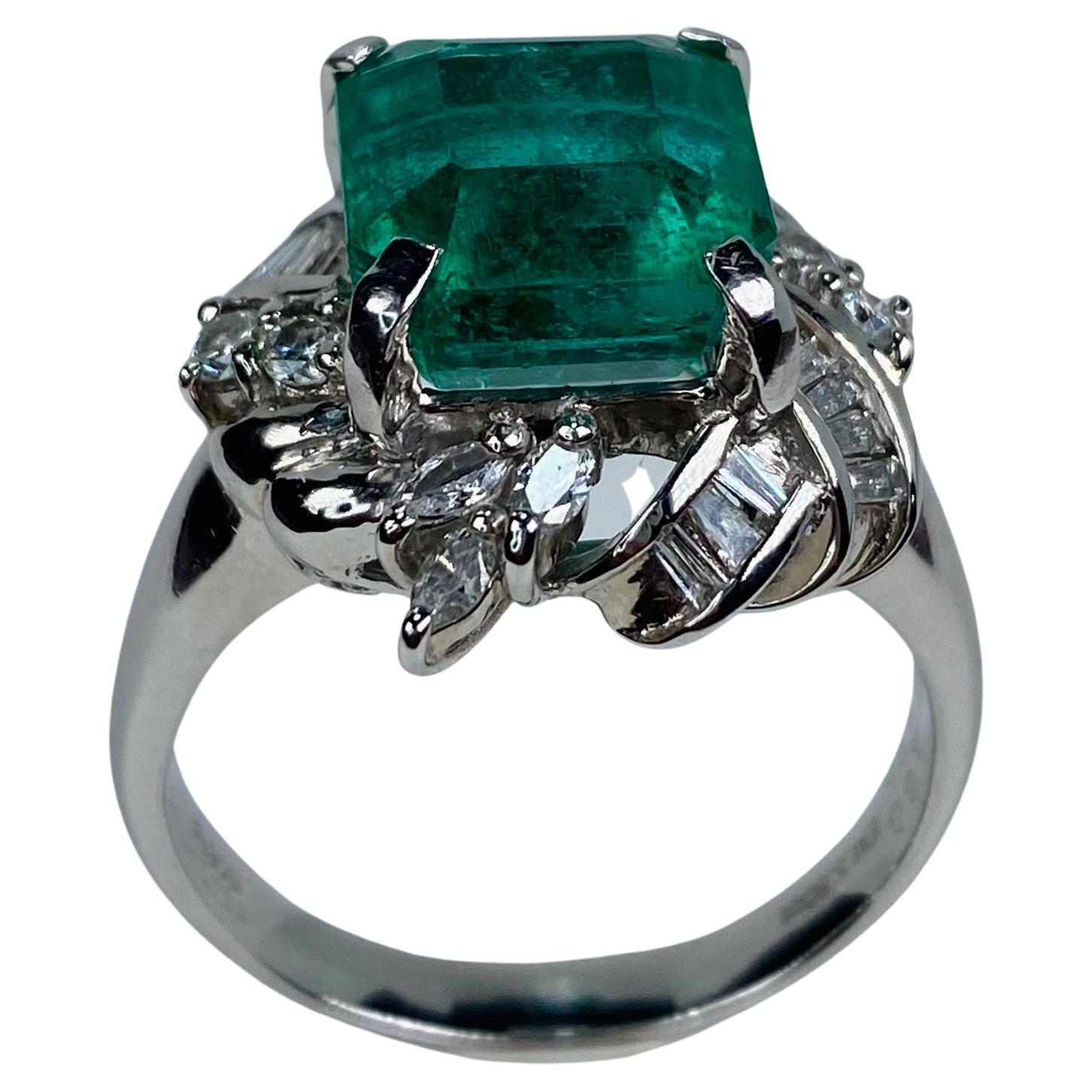 The Sapphire Merchant presents this exquisite one-of-a-kind 5.80ct Zambian Emerald ring to the 1stDibs platform. This ring is a true marvel, set with platinum and complimented with a mixture of marquise, round brilliant, and baguette diamonds. With