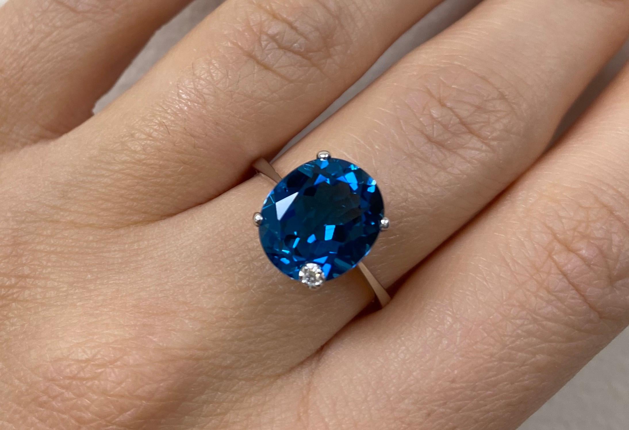 Material: 14k White Gold 
Center Stone Details: 1 Oval Blue Topaz at 5.81 Carats - Measuring 12 x 10mm
Diamond Details: 1 Round White Diamond at 0.02 Carats - SI Clarity / H-I Color 
Alberto offers complimentary sizing on all rings.

Fine one-of-a