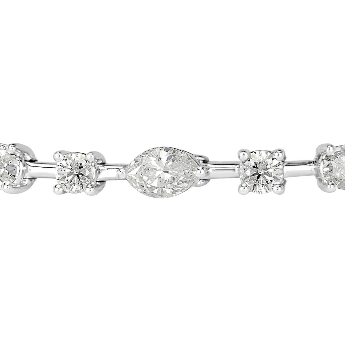 Custom created in 18k white gold, this ravishing diamond bracelet features 5.81ct of oval, marquise and round brilliant cut diamonds graded at F-G, VS1-VS2. Each individual diamond average 0.25ct.  
