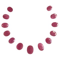 58.39 Carats Ruby Mozambique Oval Faceted Cut stone Layout Heated Natural Gem