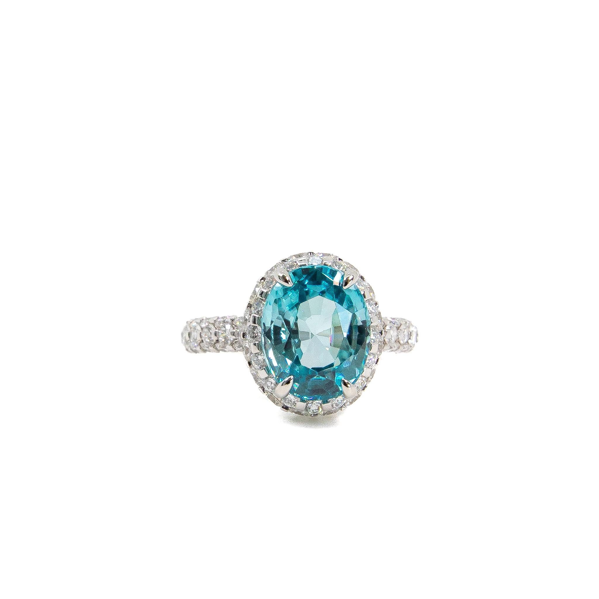 Custom-made stunning delicate pale blue oval cut natural Zircon of 5-6ct surrounded by around 1.71ct of dazzling round brilliant colourless diamonds. 

Zircon is a natural, magnificent, and underrated gemstone that has been worn and treasured since