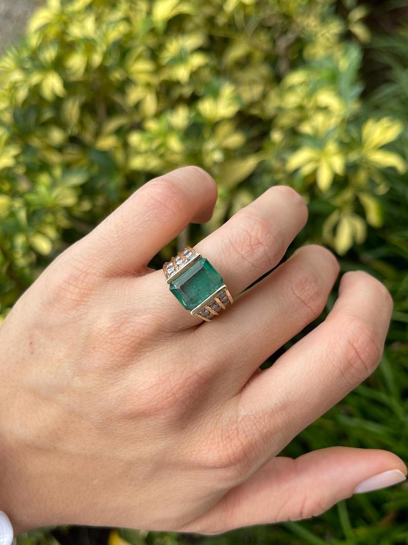 Modern 5.83tcw 14K Emerald Cut Emerald & Diamond Ring - Deep Green Tension Set Gold For Sale