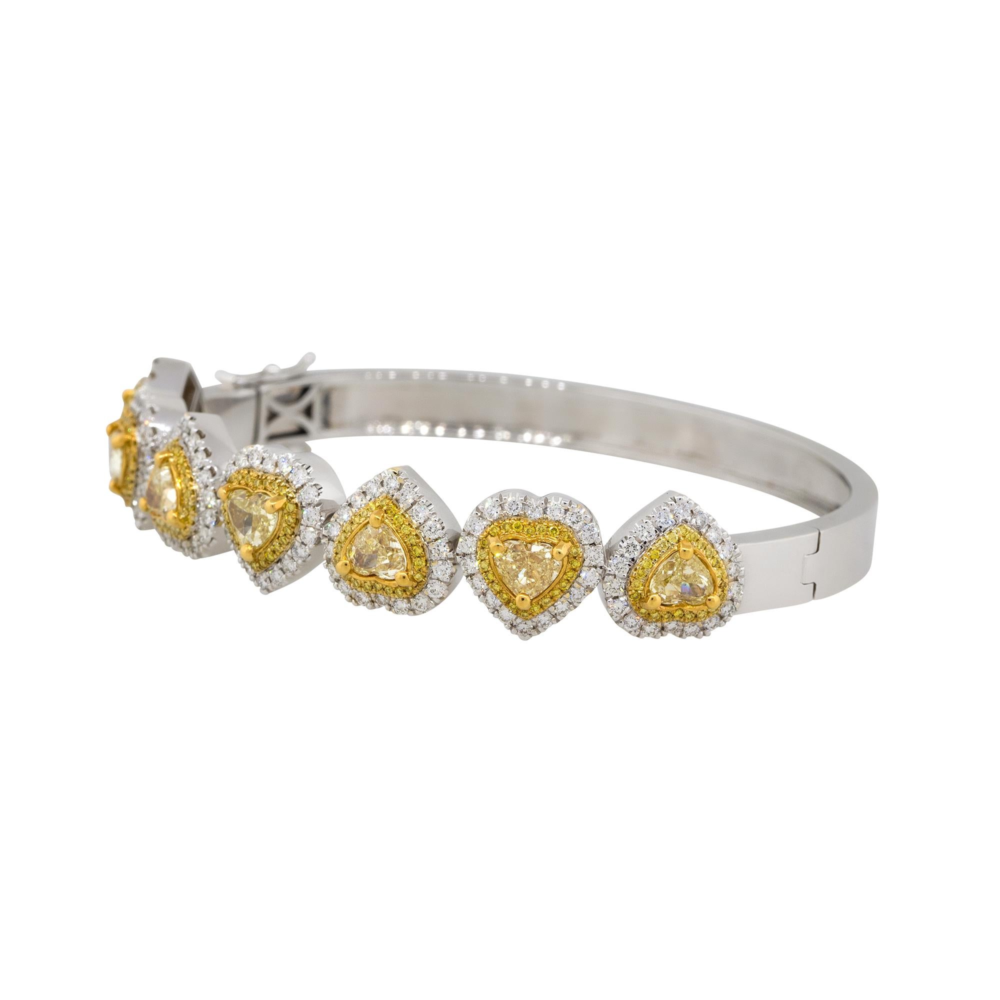 Material: 18k White Gold
Diamond Details: Approximately 5.84ctw round and heart shaped diamonds. Diamonds are H/I, Fancy Yellow in color and VS in clarity.
Clasps: Side tongue in box with safety
Total Weight: 37g (23.7dwt)
Length: 65mm x 12mm x