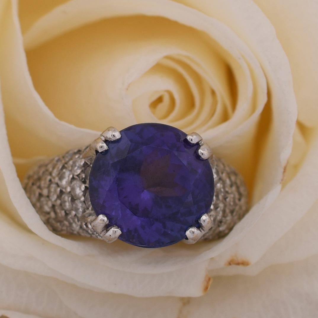 Experience the epitome of luxury with this vintage 14K Tanzanite and Pavé Diamond Ring. The centerpiece of this exquisite ring is a remarkable 5.84 carat tanzanite gemstone, known for its mesmerizing violet-blue hue that captures the essence of rare