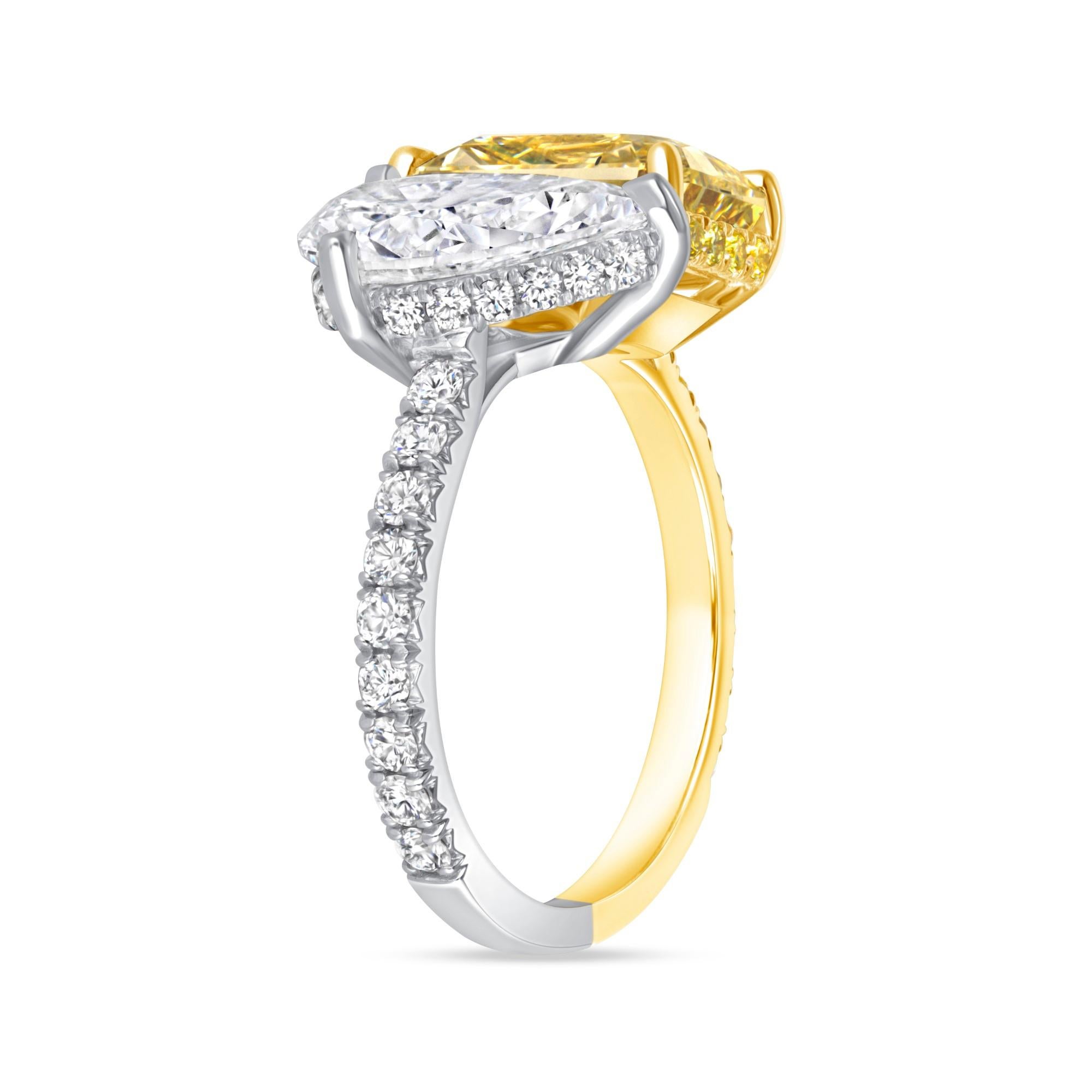 This diamond ring features with a 3.52 radiant cut diamond with GIA certified, Y-Z in color and VS1 in clarity and a 1.70 pear diamond G in color, SI2 in clarity. Set in 18K Yellow and Platinum, accented with 23 round fancy yellow and 19 round