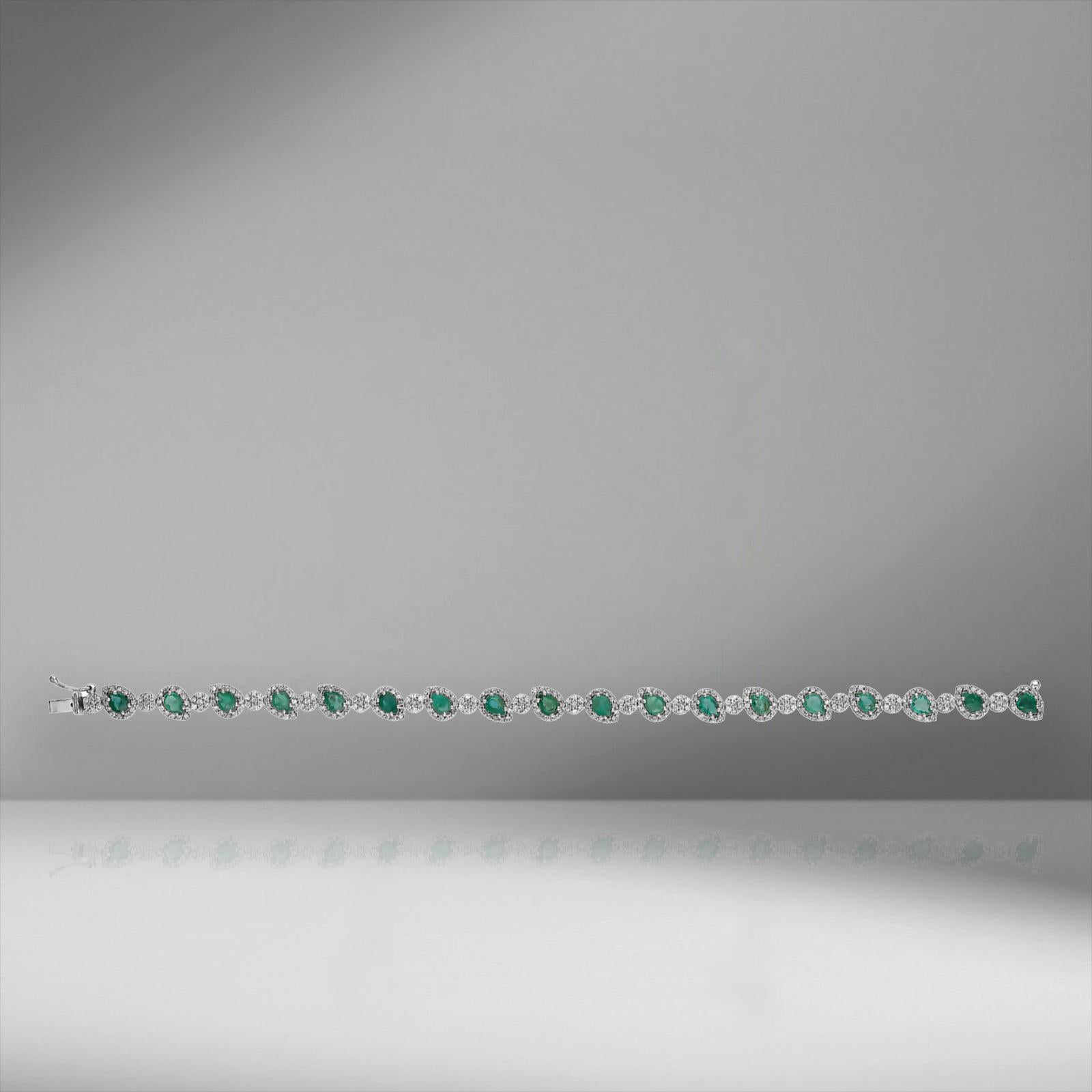 This green emerald and white diamond tennis bracelet are sure to delight a beautiful blend of contemporary and classic design elements. 
Elegant drop shape emeralds and brilliant glimmering round cut diamonds in semi-bezel settings for an elegant