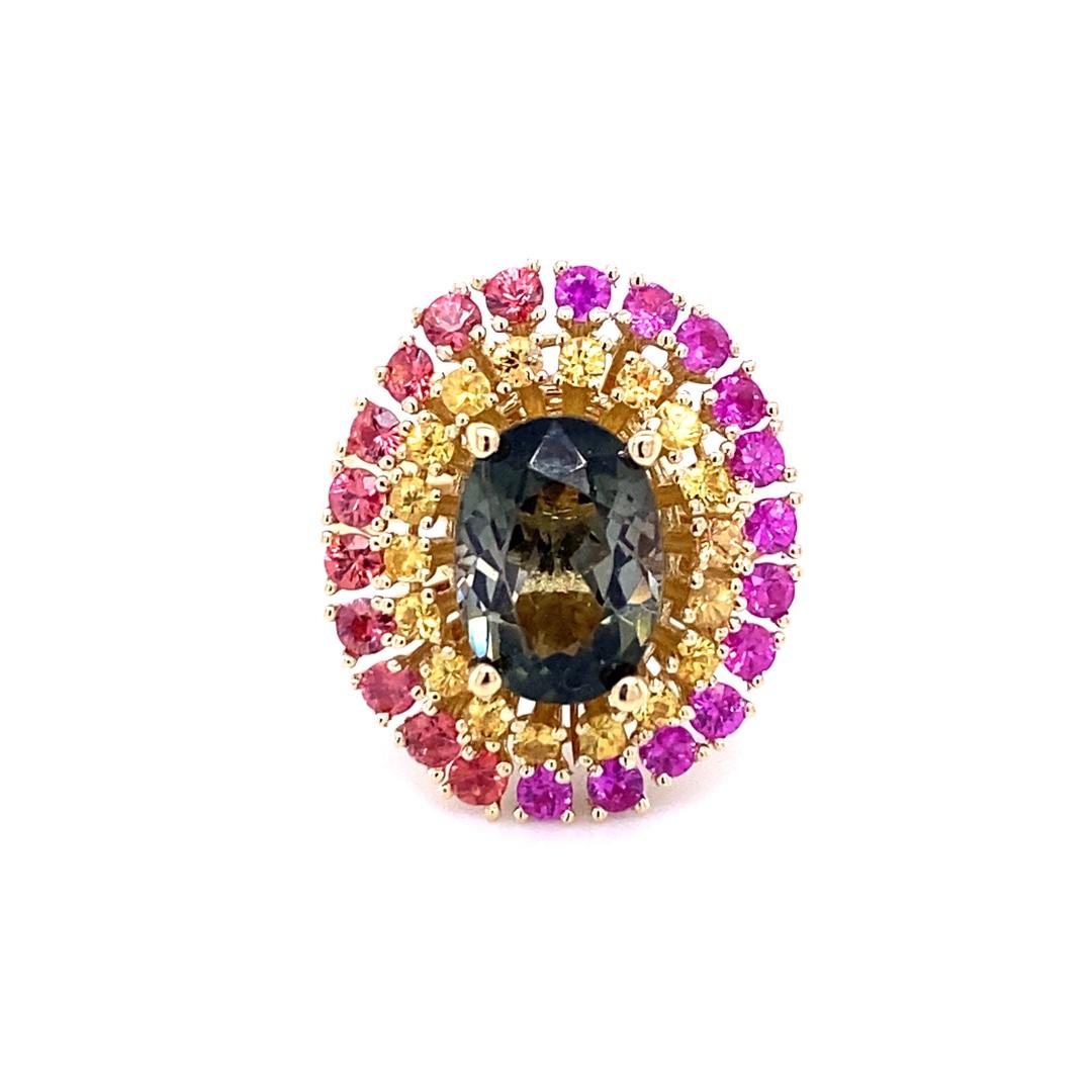 Stunning and uniquely designed 5.85 Carat Tourmaline, Red, Pink and Yellow Sapphire Yellow Gold Cocktail Ring! 

This ring has a 3.60 Carat Oval Cut Green Tourmaline and is surrounded by 40 Round Cut Yellow, Red and Pink Sapphires that weigh 2.25